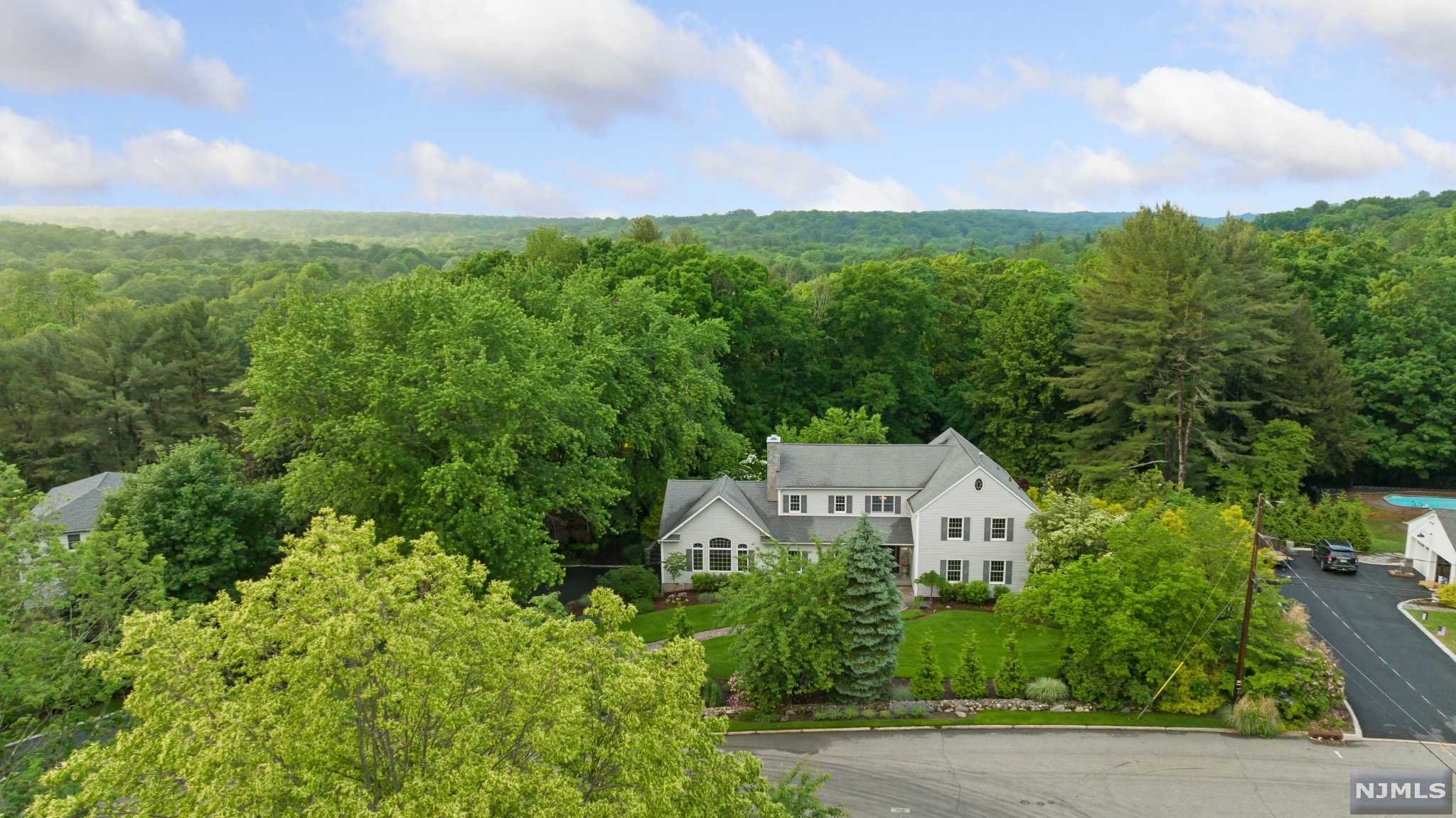 Bright/spacious center hall colonial set on beautifully landscaped, flat acre in the prime East Hill section of Upper Saddle River. New, high-end Custom chef's kitchen features Sub Zero refrigerator and 2nd Sub Zero freezer in island, Wolf stove, oven and microwave, Miele steam oven, large island, breakfast area leading to stunning, large patio, huge, very private backyard with gardens. First floor: family room w/cathedral ceilings, fireplace and built-in bar, banquet size dining room, library/living room, ensuite bedroom/office, additional BR/office, large pantry, laundry and powder room. Second floor features generous primary suite w/jacuzzi & steam shower, two walk-in closets. BR's #4, 5, 6 and a large hall bathroom. Home boasts 5 1/2' Hardwood floors throughout. Full finished basement w/wine cellar, media room, exercise room. storage including 5 - 36' x 72' wall cabinets. Newly paved driveway w/Belgian blocks, 3 car garage, 2 EV outlets. Homeowners hold RE licenses. Turnkey.