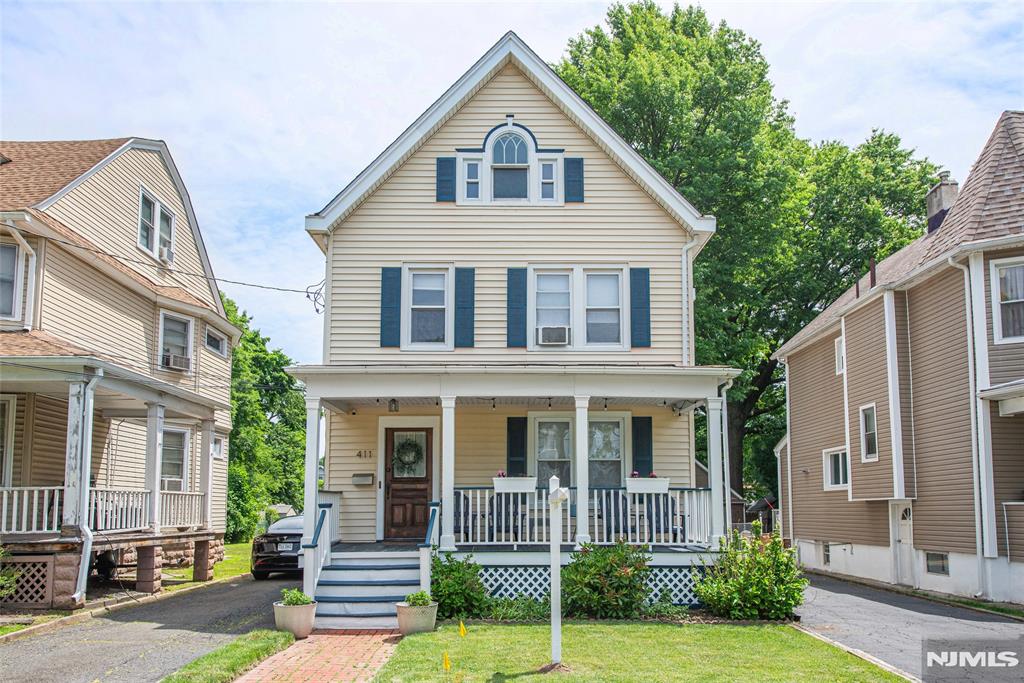 Classic two-family Colonial on a tree-lined street in Bloomfield, blending historic charm with modern convenience near the Garden State Parkway, local shops, the Montclair cultural hub and NJ Transit. Unit 1 spans the entire first floor with direct access to the large, unfinished walk-out basement featuring laundry, separate utilities, and storage. Unit 1 boasts an upgraded eat-in kitchen with durable Formica countertops, water-resistant Luxury Vinyl Down (LVD) flooring, stainless steel appliances, and subway tiles. It opens to a rear mudroom leading to the backyard (and doubles as a private entrance). The bright formal living room and main bedroom both feature original hardwood floors, while the full bath has standalone shower, glass vanity, and built-in linen storage. Unit 2 comprises the second and third floors and greets you with a large entry hallway, closet, and a spacious open-concept living/dining zone with hardwood floors, an eat-in kitchen with stainless steel appliances, a bedroom, and full bath. The third floor features a versatile "captive" flex room (ideal for an office, studio or bedroom), leading into a generous private third bedroom. Two separate driveways eliminate parking issues. One private paved driveway fits 3-4 cars; one shared driveway leads to a shared garage with 1 private for you. This lovely home has replacement windows throughout and separate utilities. Ideal for investors or owner-occupants looking for rental income. Don't miss!