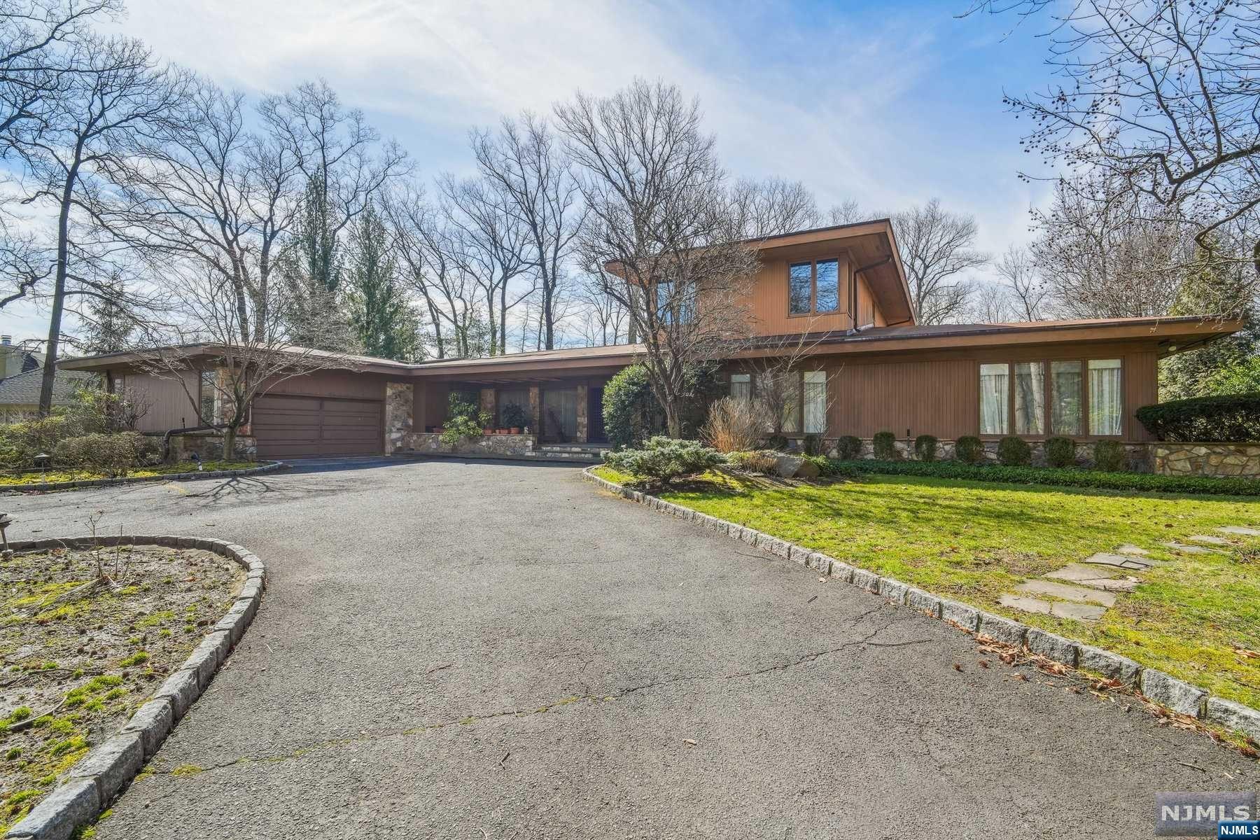 PHOTOS TO FOLLOW. Welcome to Tenafly's East Hill. This Contemporary home on almost one acre of landscaped property with a Koi pond at the front entrance offers so much. Pool with cabana containing his and her bathrooms and full service kitchen, 6 Bedrooms, 4.5 Bathrooms, lower level features recreation room, bedroom and full bath. Formal living and dining room, music room, open eat-in kitchen with large island.