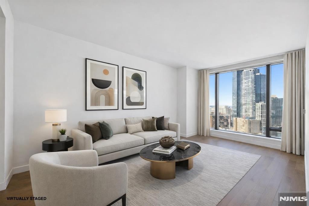 Elevated lifestyle meets luxury ownership at 99 Hudson. Stop renting and start building equity in this stunning 26th-floor residence featuring floor-to-ceiling windows, abundant natural light, wide-plank oak floors, Bosch appliances, a gas range with vented XO hood, white lacquer Italian cabinetry, spa-inspired baths, and in-unit laundry. Enjoy over 65,000 square feet of resort-style amenities, including one of New Jersey's largest residential outdoor pools, private cabanas, hot tub, landscaped green spaces, fitness center, yoga and Pilates studio, sauna, steam room, golf simulator, resident lounges, business center, children's playroom, dog run, and 24-hour concierge and doorman service. Located in the heart of Downtown Jersey City's waterfront, just moments from the PATH and NY Waterway Ferry, offering an easy Manhattan commute and the perfect blend of luxury, convenience, and long-term value.