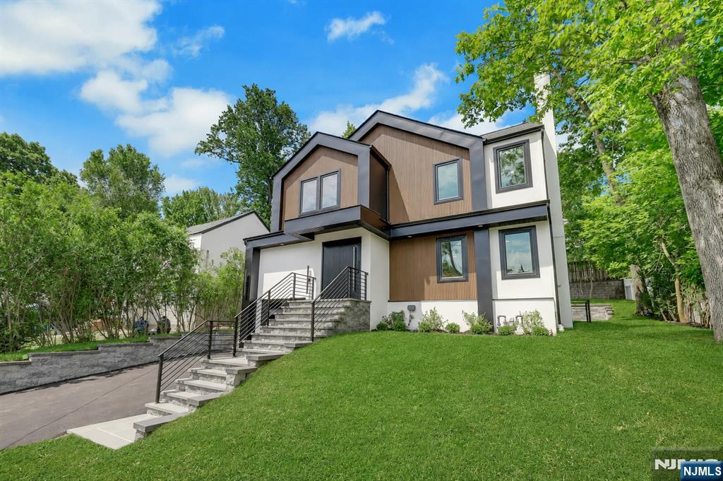 Exceptional contemporary new construction featuring a thoughtfully designed, light-filled open layout and exceptional modern living throughout. The first level showcases a sun-drenched living room with a wood burning fireplace, formal dining room, and spacious family room with an electric fireplace. The stunning modern eat-in kitchen and family room open to the private backyard through oversized sliding doors, creating effortless indoor-outdoor living. A powder room and mudroom complete the main level. The second floor offers a primary suite with a primary bath and walk-in closet, an ensuite bedroom, an additional two bedrooms, a full hall bath, and convenient laundry. The fully finished lower level expands the homeâ€™s versatility with a recreation area, additional bedroom, and full bathâ€”ideal for guests, work, or extended living. The house is flooded with natural light and designed for both comfort and style, this exceptional home delivers standout appeal in todayâ€™s market. Conveniently located close to schools, down town, parks and NYC transportation