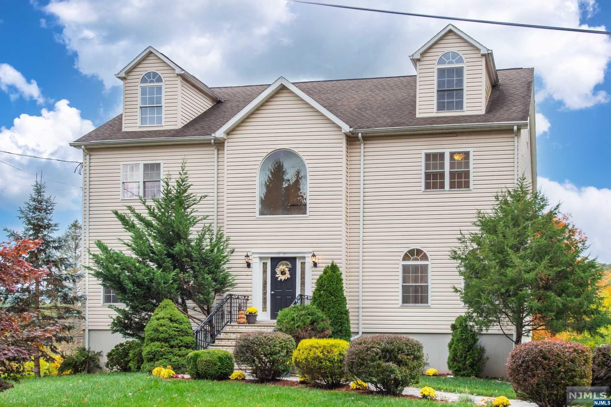 Get ready to be impressed with this gorgeous Colonial! All are greeted in the two-story foyer with a mix of charm and modern style. The first floor offers an open concept with a light, bright living room, a formal dining room, a powder room and a beautiful HGTV kitchen with a center island, quartz counters, white and gray cabinets with stainless steel appliances which then opens to the family room with a fireplace. The second floor offers four bedrooms and two full bathrooms, including the large master suite with master bathroom with sliders to a nice deck, double vanity, soaking tub, stall shower and a walk-in closet with a "Container Store" closet system. The home offers an attic with 1,500 sq ft that may be finished for additional living space as well as a partially finished basement. Outside offers lush surroundings with breathtaking lake and mountain views. Located in the Forest Hill Park private lake community. Minutes to major highways and bus to NYC.