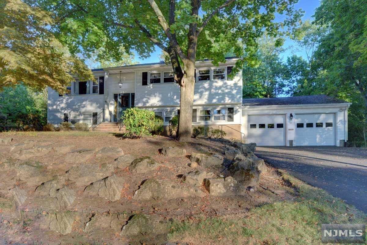 The timhas arrived to make this welcoming Bi-Level your own! Wonderful area of Wayne with top rated schools. This large Bi-Level offers 3 bedrooms, 2 1/2 baths, formal living and dining room, eat-in kitchen with access to large deck perfect for entertaining; while overlooking a beautiful yard. First level has master bedroom with full bath plus 2 additional bedrooms. Ground level with office/den; workshop area with plenty of storage, access to oversized 2 car garage. Lower lever has large family room with slider to updated enclosed porch with walkout to paver patio. This property features a large lot with endless possibilities! Wayne offers NJ Transit Bus & Train station on Rt. 23. Close proximity to shopping and schooels.