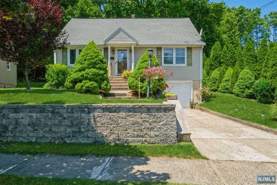 Welcome to your new home! Meticulously maintained 3 bedroom Cape Cod featuring newer AC, hardwood floors, a bright, spacious living room, dining room, kitchen featuring stainless steel appliances with door to the backyard. Two large bedrooms w/ plenty of closet space & a full bathroom will also be found on the 1st floor. The top floor features a private bedroom with a spacious closet, as well as a large attic; plenty of room for storage. Full, finished basement with direct access to attached oversized garage. 2 car driveway. Quiet street. Private backyard with woods behind. Patio featuring pavers, fire pit, newer shed and beautifully maintained landscaping; perfect for relaxing or entertaining! Close to shops, great schools, NYC transportation, major highways. A commuter's dream!