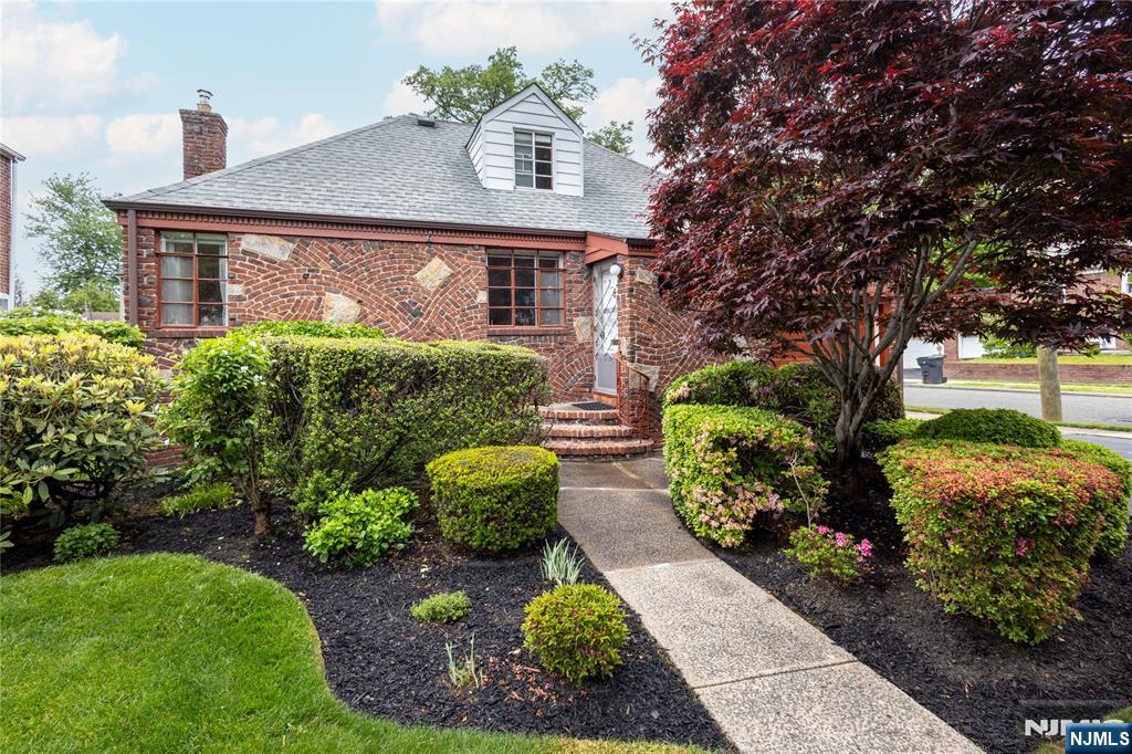 Charming Brick & Stone Expanded Ranch on a Corner Lot in Bergenfield bordering sought-after towns like Tenafly! Ideal for NYC commuters with the NJ Transit #166 bus right across the street. This beautiful well-maintained 3BR/1BA home blends timeless characterâ€”original hardwood floors, arched entries, and wood doors with comfortable living. The main level offers a practical layout with two bedrooms near a full bath, while the finished upper level serves as a third bedroom with oversized closets and built-in storage. The house offers flexibility for todayâ€™s lifestyle featuring central A/C (plus supplemental window A/C unit on second level for added comfort), gas forced air heat, attached 1-car garage, double-wide driveway and partially finished basement with built-in shelving and office workspace. The thoughtfully-designed kitchen includes a Sub-Zero built-in refrigerator, gas stove, dishwasher, water filtration system, ceramic tile flooring, roll-out pantry drawers, and custom built-ins for added functionality. Step outside to enjoy a spacious private backyard framed by mature perimeter bushes creating a peaceful setting perfect for relaxing or entertaining. Recent updates: Roof/Gutters (2018), Furnace (2019), Hot Water Heater & Sump Pump (2022), Utility Sink (2025) add to mechanical confidence. This home is a wonderful opportunity offering comfort, convenience, and long-term potential. House is sold as-is.