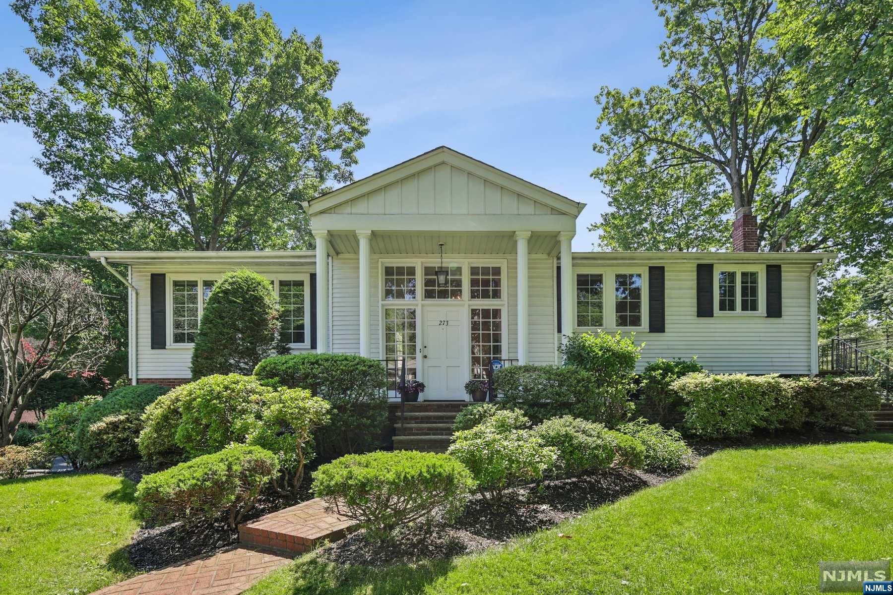 Welcome to this contemporary bi-level home, situated on a picturesque corner property in Englewood Cliffs. The dramatic entrance leads to a sun-drenched living room and dining room, featuring vaulted ceilings, oversized windows, and beautiful hardwood floors. The kitchen, with its charming breakfast area, offers a bright and welcoming space. The main level features a large primary bedroom with an en-suite bathroom, alongside two additional bedrooms and a bathroom. Downstairs, the spacious family room opens to an expansive patio and a beautifully landscaped yard. The lower level also includes a sizable bedroom, bathroom, laundry area, and a two-car garage. Perfect for both entertaining and tranquil living, this home offers low property taxes and is just minutes from New York City and major highways.