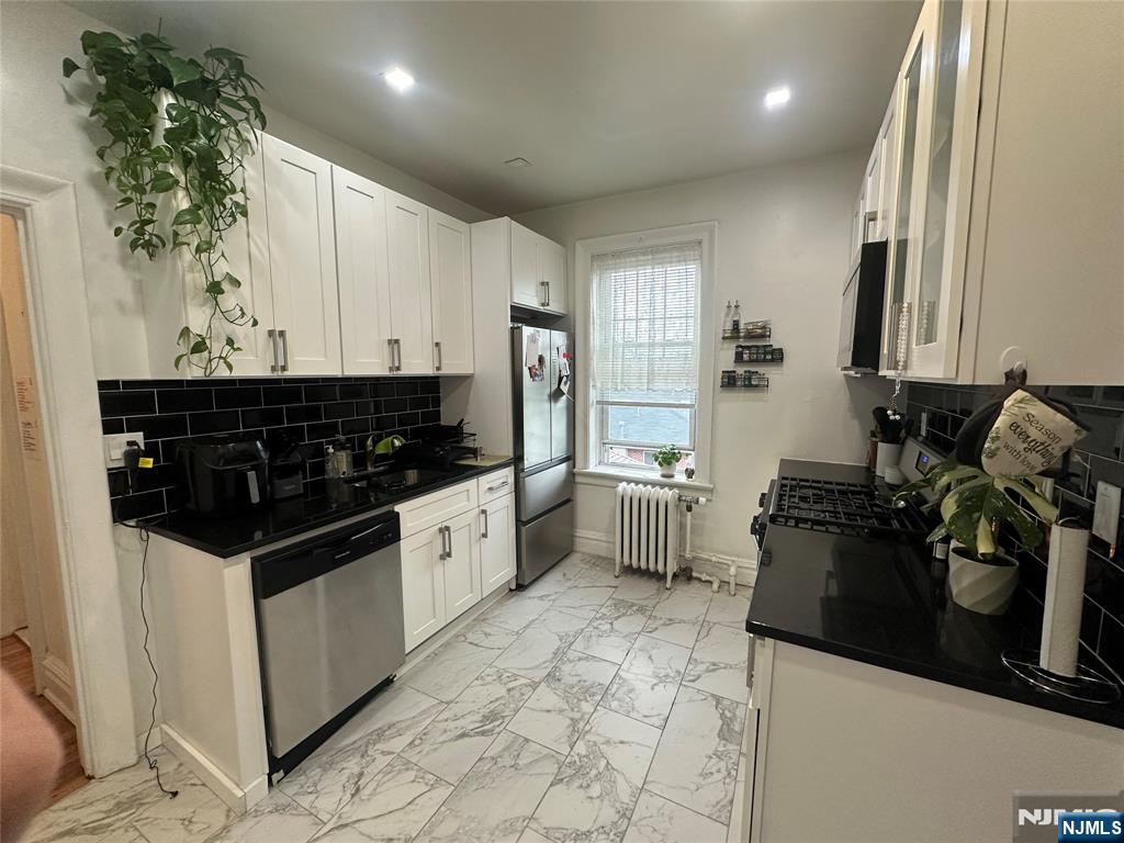 This beautifully updated apartment combines classic character with modern comfort. This bright, spacious units feature 9' ceilings, hardwood floors, a modern kitchen, and quality finishes throughout. Conveniently located near shopping, dining, parks, and transit, offering quick access to NYC, Edgewater, major highways, and direct NJ Transit service to Port Authority. Heat and Hot water are included in rent! Shared laundry available in the building! Don't miss this opportunity, schedule a tour now!