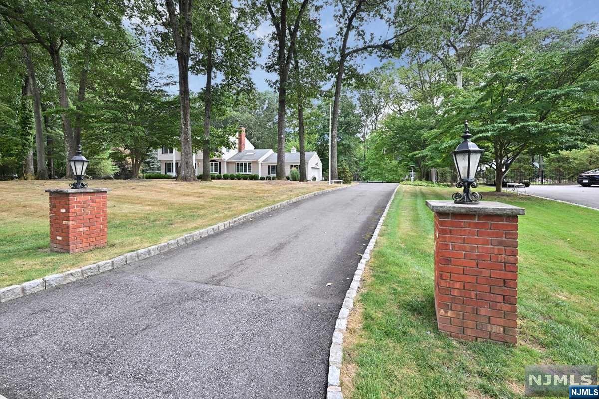 Welcome home to this classic center hall colonial located in the highly desirable Fardale section of Mahwah. You will love the location, the 3000+sf of living space, the level acre of property with lots of privacy, and the low, low taxes in Mahwah. The heart of the home is the spacious kitchen with large island and plentiful seating for all to congregate and enjoy a meal. Then step through the slider to the large covered deck overlooking the inground heated pool. It's the perfect set up for outdoor entertaining and offers the bonus of enclosed sun porch. Snuggle up to the double sided brick fireplace that can be enjoyed in both the family room and kitchen. Upstairs you will find the master bedroom suite and 3 additional bedrooms with bath. There's more fun to be had in the finished basement that includes recreation area, full bathroom and stair access to grade level 2 car garage. Hardwood floors are throughout the entire home. Convenient to Ramapo Mtn. hiking, Golf, and Skiing.
