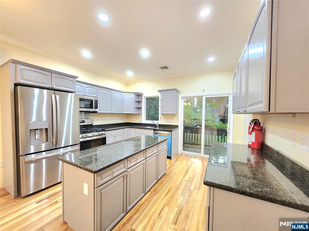 ***RENOVATED Beautiful and bright 1ST FLOOR WITH BASEMENT (Separate entrance door to outside)***. TOP/BOTTOM STYLE 2-FAMILY HOUSE WITH PRISTINE, MODERN DESIGN. 1st floor features : 3 BEDROOMS, 2 FULL BATHS, LR & DINING ROOM WITH A FIRE PLACE (gas), LAUNDRY ROOM, MODERN EAT-IN-KITCHEN WITH GRANITE COUNTER TOP and *** ALL BRAND NEW STAINLESS STEEL APPLIANCES ***. SLIDING DOOR TO BACK YARD AND PATIO, *** Brand new WASHER/DRYER IN THE UNIT***. Fully finished basement on ground floor has a family room or Recreation room and one full bath, access to garage and SEPARATE ENTRANCE door to outside ***. VERY CONVENIENTLY LOCATED TO NY BUS, SCHOOLS, PARKS, SHOPS & RESTAURANTS and must see!!!