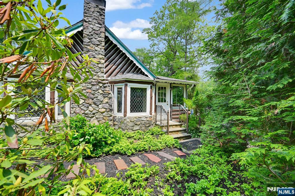 Beautiful Native American Chestnut Log Home With Outdoor Entertaining Oasis! Pride Of Ownership Shines In This Stunning Log Home, Lovingly Cared For By Its 2nd Owner For 38 Years! Set On A Landscaped Corner Lot With Flowering Bushes, Shrubs, And A Babbling Stream Channel, This Property Offers Peace, Privacy, And Standout Features! The Backyard Is An Entertainer's Dream With A Spacious Paver Patio And Custom Gourmet Lynx-Equipped Outdoor Kitchen, Featuring A Wood-Fired Oven From Modena, Italy, Built-In Grill With Infrared Burner & Rotisserie, Dual Side Burners, Sink, And Half Fridge! Inside, The Country-Style Kitchen Flows Into A Bright Dining Room With A Pass-Through Window! A Cozy Den Offers Side Door Access To The Lower Patio! The Living Room With A Floor-To-Ceiling Stone Fireplace Reaches Into The Cathedral, And Twin Window Seats With Custom Stained-Glass Windows Imported From Germany! The Large Primary Bedroom Offers A Double Closet And Direct Bath Access; The Second Bedroom Features Two Closets! A Loft Overlooks The Living Space - Ideal As A Reading Nook Or Office! Optional Lakeside Beach Club Membership On Greenwood Lake Offers Boating, Jet Skiing, Kayaking, And More! Minutes From Hudson Valley Orchards, Shopping, And Legoland! This Home Is The Perfect Mix Of Rustic Charm And Modern Comfort! Schedule Your Tour Today!