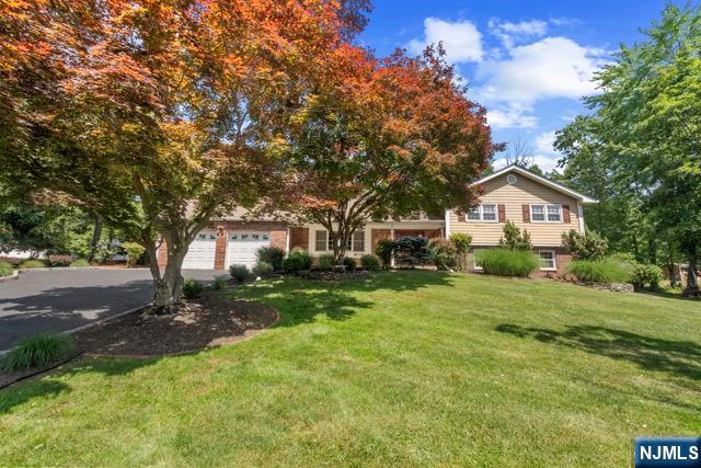 Nestled on a beautiful, park-like .76-acre property in one of Montville's most desirable neighborhoods, this warm and inviting Split offers the perfect blend of comfort, space, and charm. The moment you arrive, you'll appreciate the peaceful setting, mature landscaping, and sense of privacy that make this home truly special. Featuring 4 spacious Bedrooms, 2 FBs, and 2 HBs, this home offers plenty of room for both everyday living and entertaining. Natural light fills the home, creating a welcoming atmosphere throughout, while the thoughtful designed floor plan allows for easy customization and future expansion. Whether you're hosting holidays or special occasions, enjoying cozy evenings by the fire, or entertaining guests, the generous layout offers comfort and relaxation, making it ideal to accommodate large gatherings. Step outside onto a 1000 sq. ft. patio and discover a backyard setting that invites relaxation, outdoor dining, and endless possibilities for recreation. Ideally located near top-rated schools, parks, shopping, dining, and major highways, this exceptional home offers the perfect balance of privacy and convenience. Beyond its spacious layout, beautiful setting, and timeless appeal, this home offers the peace of mind today's buyers are looking for. The roof is 5 years old and includes a transferable warranty. Numerous additional upgrades and updates have been made throughout the home, reflecting the care and pride of ownership that is evident throughout.
