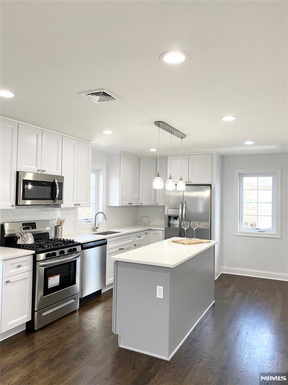 RECENTLY BUILT DESIRED TOP UNIT, BRIGHT & OPEN concept w/ hardwood floors and recessed lighting throughout! Bordering Hasbrouck Heights/Wood Ridge. Modern day living. Comes with rugs. Designer gourmet Chef's kitchen w/ QUARTZ countertops + custom backsplash. Custom Cabinetry + Custom Pendant Lights. SS appliances. PRIMARY bedroom w. EN SUITE BATH + HUGE walk in closet. All bedrooms have large closets. Central A/C + Heat. Comes with SECURITY DOORBELL exclusively for tenant. Massive backyard! IN-UNIT LAUNDRY. Plenty of 1 way street parking. EZ access to transportation. PET FRIENDLY 1 time fee $299 per pet (subject to approval) $100/mo flat water fee. *Xtra storage in large attic AT NO ADDITIONAL COST*
