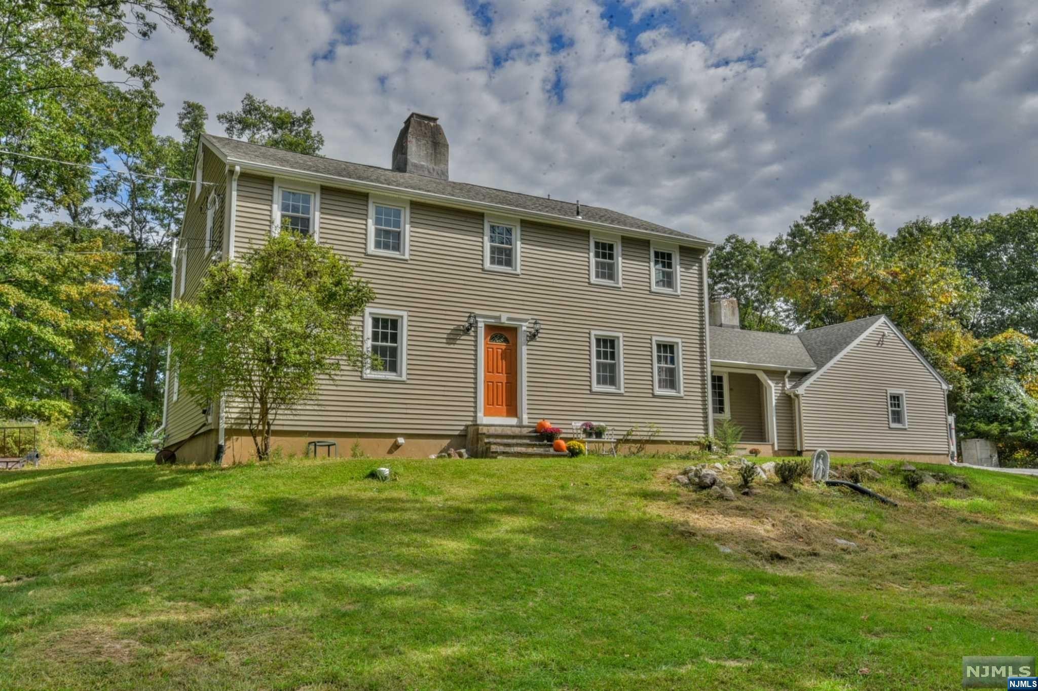 Welcome home! This private retreat with 5 ACRES of property has everything you've been looking for and more! Get ready to pour a glass of wine after work and enjoy the peace and quiet that surrounds you. This warm, comforting home is ready for you to relax, start the fire, and leave the hustle and bustle of the outside world behind. Tranquility and serenity abound in this unique home and property, and it's ready for new memories to be made. This 4 possibly 5-bedroom home with 2.5 baths offers privacy and is surrounded by nature's beauty, all encompassed in the beautiful town of Kinnelon, which boasts a top-rated school system and is in close proximity to shopping, highways, and public transportation. The possibilities are endless in your country retreat, with blackberry and raspberry bushes lining the driveway to the private backyard, ready for outdoor parties, firepit bbqs, and the slow sipping of coffee while you watch the sunrise. Get ready to fall in love!