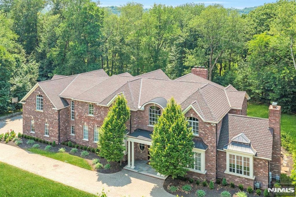 Step into timeless elegance and refined living with this private,8,200sf all brick colonial located on 1.3 acres backing up to Green Acres Preserves on one of the most prestigious blocks in town.The main living area boasts an effortless flow,perfect for intimate gatherings and large entertaining.Chef's kitchen incl 2 ovens & 2DWs,custom cabinetry and large island.Adjacent to the kitchen is a family room with a wet bar and FPL.Floor to ceiling french doors open to a bluestone patio creating a seamless fusion of indoor & outdoor living.Beautiful paneled office w/FPL.2nd fl primary suite offers an abundance of light and high ceilings,spa-like bath,his-and-hers WICs.4add'l large BRs upstairs,all with en-suite full baths,2 with WICs.1st floor BR with en-suite,perfect for guests or live-in. 4,000sf bsmt with 9+ft ceiling,FPL & walk-out.Custom trim throughout,circular driveway & 5 car garage.2 minutes drive to country club-tennis,lake and pool.