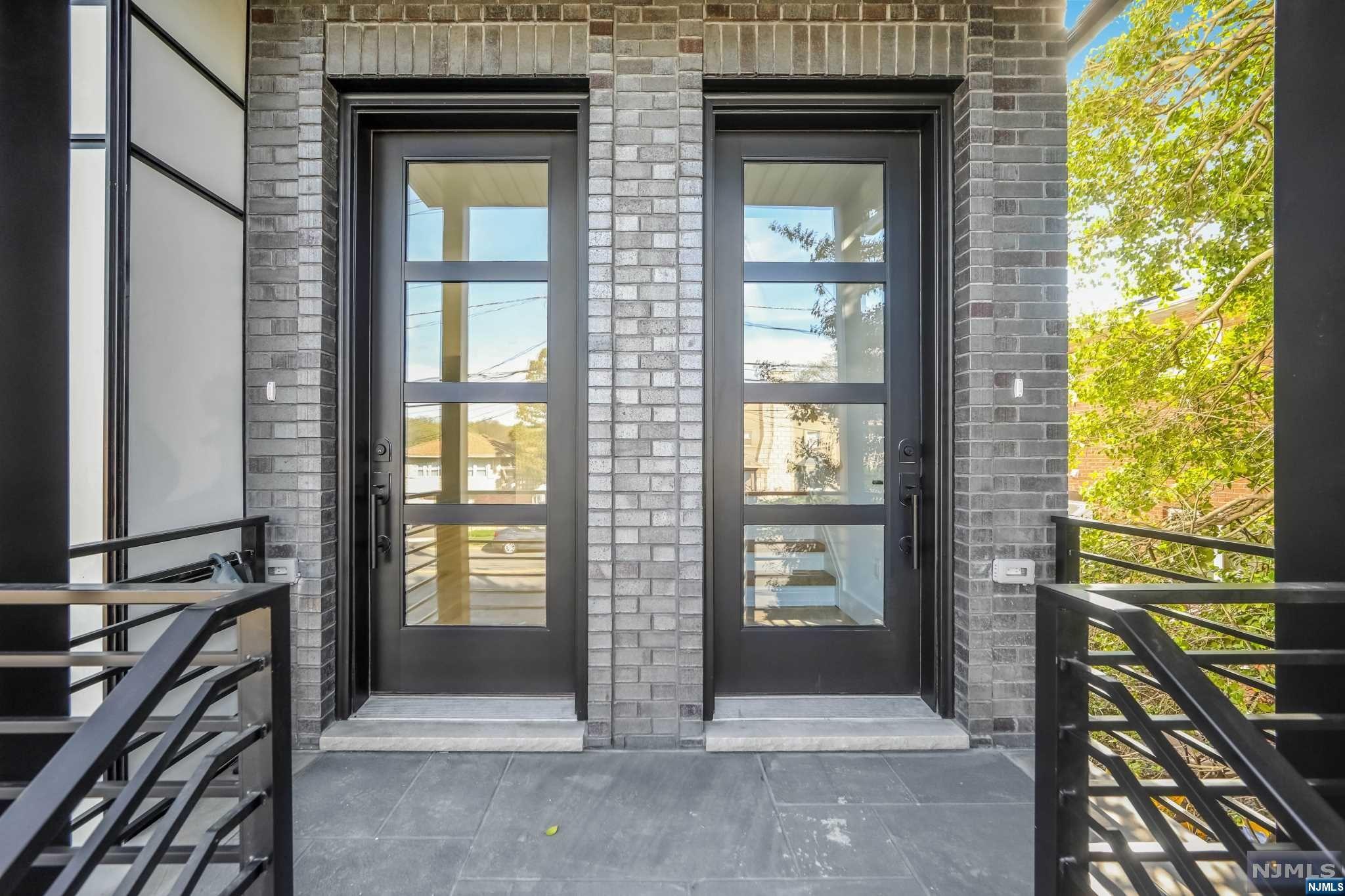 A modern new construction two-family home! The first and second floor unit of this home is a spacious 9-room living space with 2.5 baths. This home features sun-filled rooms and 9' ceilings throughout, creating an airy and open feel. As you enter your front door , you are welcomed into a spacious living room with plenty of natural light. The open floor plan leads into the kitchen, which is outfitted with modern appliances and ample counter space for meal preparation. The kitchen also has a sliding glass door that provides access to a private deck, perfect for outdoor dining or relaxation. Each unit has three generously sized bedrooms, each with large windows that let in plenty of sunlight. The master bedroom has an en-suite bathroom, complete with a modern glass-enclosed shower. The other two bedrooms share a full bathroom that features a tub and shower combo. The main unit also has an additional 3 room -1/2 bath, finished ground level with side entrance and sliding glass door.