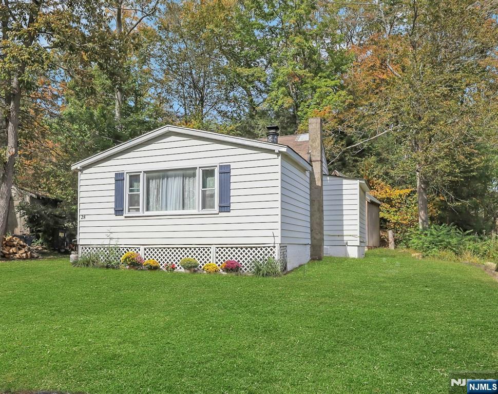 Why rent when you can own? Adorable 2 BR ranch on a rare, rearly 1/3 acre (.297 acres) lot. Enjoy peace and tranquility year rround or as your weekend and Siummer getaway! Enjoy Upper Greenwood Lake Property Assoc. Lake rcights (private beach, lifeguards, clubhouse, fishing, motor boats, water/jet skiing). This home features a lving room with sunny bay window & wood burning stove, newer septic, updated bath. New water heaterr May 2026. The walk-up second level ofrers endless expansion possiblities. Knotty pine interior for a rustic, cabin-like feel. Enjoy Summers at the lake and Autumnn at the wineries & Apple Festival in nearby Warwick,, NY. Greenwood Lake Property Owners Association Annual fees: easement: $291/yr, POA: $340/yr.