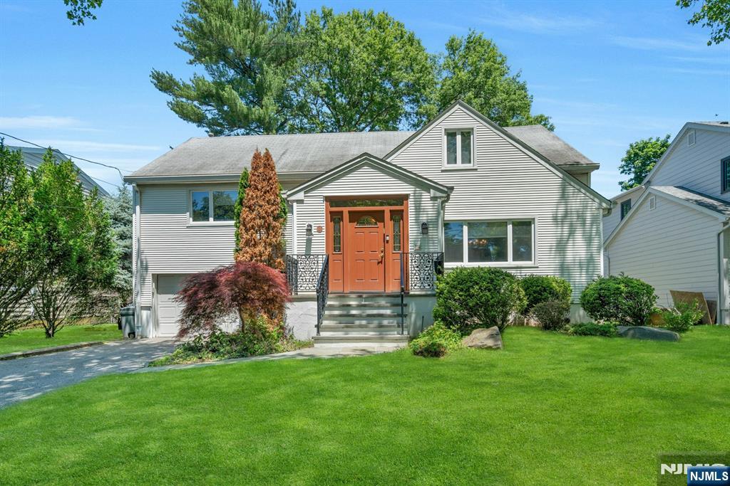 This deceptively expansive split-level home with over 3800sf of well-designed living space is situated in the heart of West Englewood and offers comfort, convenience and versatility. The stately front door welcomes you into a bright atrium foyer with two coat closets and convenient powder room. Beyond two attractive French doors is an elegant formal dining room where natural light streams through the large picture window, creating an inviting atmosphere for special gatherings. Enjoy an updated eat-in granite kitchen featuring 2 ovens and sinks, newer 5-burner stovetop, rich cherry wood cabinetry and a peninsula. A dramatic focal point of this special residence is the impressive great room with vaulted ceiling that provides the perfect setting for entertaining. Ascend half a flight to the expanded bedroom level boasting 4 generous bedrooms, including an ensuite bedroom, a main hallway bathroom and convenient laundry. The top floor hosts a huge primary suite with spacious modern bathroom, a walk-in closet, reading nook & easy access to a vast attic storage area. The sprawling 2 lower levels include abundant storage and flexible finished recreational & office space that can be tailored to suit your needs, with ground floor bedroom, powder room, separate entry, and direct garage access. Other features include a lovely private yard with patio, 4 zone central air and heating (3 units), 3-zone sprinkler & alarm system. Close to houses of worship and NJ Transit bus.