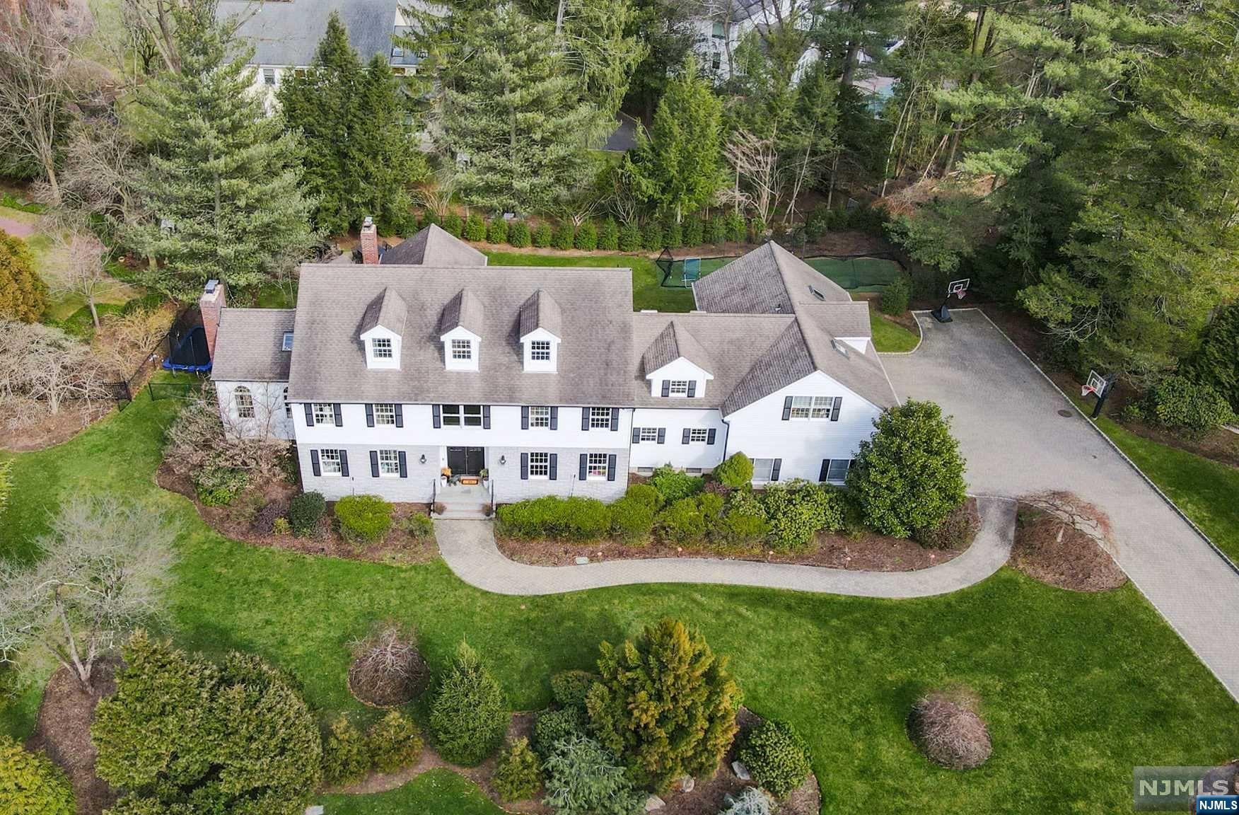 ALL OFFERS IN BY TUESDAY 3/21 at 12pm. Completely renovated this spacious & stunning home offers 6920+/- SQ FT of the ultimate living experience. A 2-story entry seamlessly flows into an open kit/breakfst area & grt rm. A chef's dream; the kitchen boasts WOLF 8 burner oven,paneled SubZero F/F,2 bev.drawers & 2 Miele dw's. A 14' island seats 6+,ideal for family & entertaining while the massive bookmatched marble fplc defines the transition btwn kit & grt rm.Drenched in nat light w/vaulted ceiling, the great room has a custom-paneled fplc wall marrying design & comfort; the wet bar makes this rm a show stopper! Indulge in a luxurious primary bdrm retreat w/gas fplc,outfitted & spacious dbl closets + a spa-like bth w/radiant heat. 4 addl ensuite bdrm/bths do not disappoint all offer gorgeous hardwood floors. The LL fts a rec room & gym. Boasting approx 3/4 acre, entertain outdoors enjoying a lrg patio with KIT & private park-like flat bkyrd. W/Wgen + lrg finished Bonus rm on 3rd fl