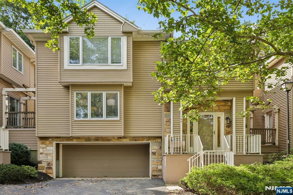 Well maintained, thoughtfully updated, and move-in ready, this freshly painted townhouse offers the perfect blend of comfort, style, and low-maintenance living. Soft, contemporary colors complement the open-concept living and dining area, which flows seamlessly into the updated kitchen, adjoining family room, and private rear deckâ€”ideal for entertaining or relaxing while enjoying a connection to nature. The heart of the home is the updated kitchen featuring a movable center island, stainless steel appliances, new quartz countertops, and modern lighting. The adjoining family room showcases custom floor-to-ceiling built-ins, providing abundant display space for books, artwork, and treasured keepsakes. Upstairs, the spacious primary suite offers a sitting area, walk-in closet, and private en-suite bath. A generously sized second bedroom, full hall bath, and convenient second-floor laundry complete the level. The finished lower level provides flexible space for a home office, media room, fitness area, or quiet retreat. Direct interior access to the oversized two-car garage adds exceptional storage and everyday convenience. Offering the privacy of a single-family home with the ease of condominium living, this beautifully maintained residence is ready for immediate enjoyment. Simply unpack and start enjoying a lifestyle of comfort, convenience, and tranquility from day one.