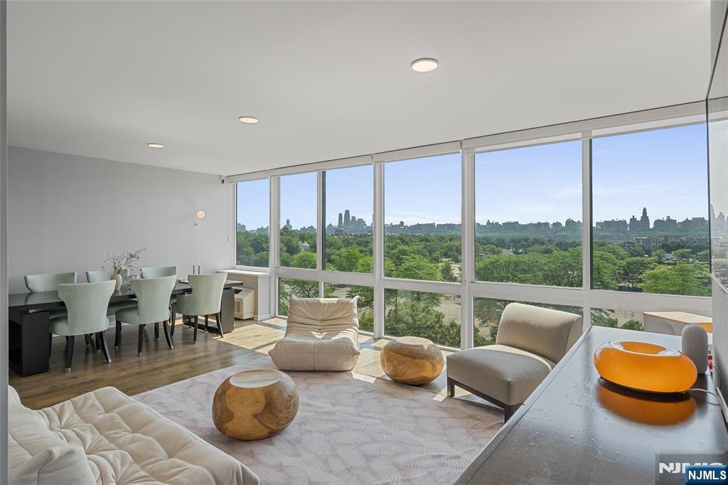 Welcome to Unit 618 at One Hudson Park, a beautifully renovated southeast-facing corner residence offering 1,589 sqft. of luxurious living space. This elegant 2 bedroom, 2.5 bathroom home features breathtaking views of the Manhattan skyline and is filled with natural light through dramatic 9-foot floor-to-ceiling windows. Designed with comfort and sophistication in mind, each bedroom includes a private en-suite bathroom, custom-built closet systems, and Hunter Douglas dual-layer blackout/sheer shades. The home also features premium engineered hardwood flooring throughout and high-end renovations completed in 2022. The designer kitchen showcases quartz countertops w/a seamless quartz backsplash, premium fixtures, a built-in wine refrigerator, and spacious pantry cabinetry. Renovated bathrooms; porcelain tile, Toto one-piece toilets. Additional highlights include economical gas cooking/gas heating (included in the monthly maintenance), 2 side-by-side garage parking spaces+a large private storage room. One Hudson Park offers exceptional amenities, including an indoor swimming pool, a newly renovated fitness center, a rooftop terrace w/outdoor seating, entertainment areas, concierge, on-site management. Ideally located just steps from Edgewater Commons, enjoy convenient access to shopping, restaurants, the NYC bus, and the shuttle to the Port Imperial Ferry-making this a true commuter's dream and the perfect blend of luxury and convenience.
