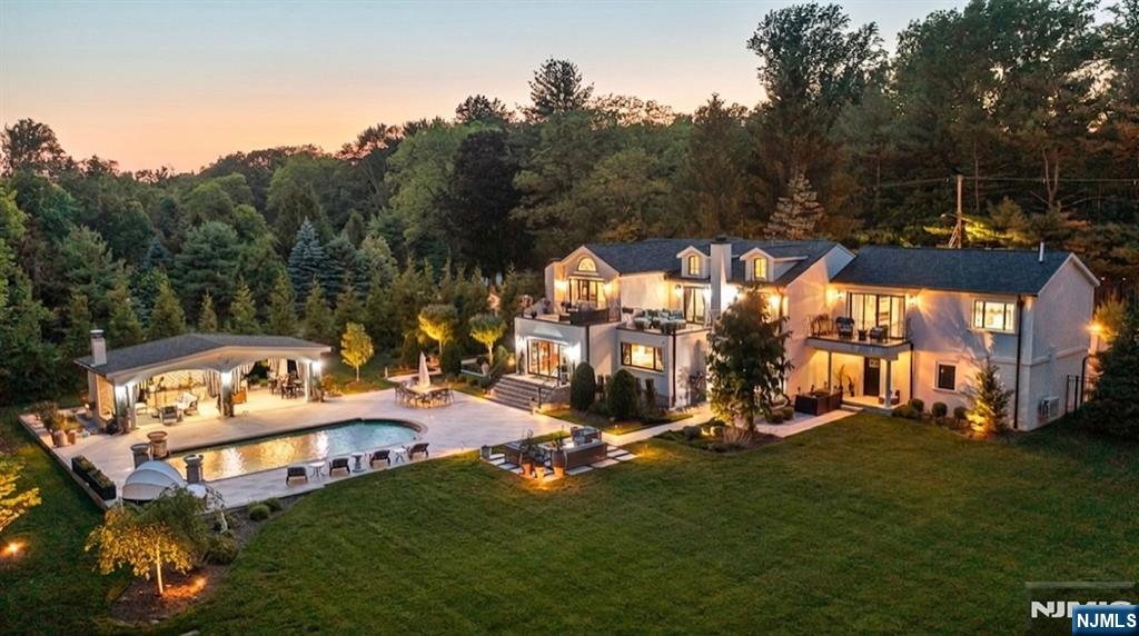 Welcome to Villa Santorini, an extraordinary Montvale estate where timeless elegance meets resort-style living on a private 1-acre property. This move-in ready home offers 4 bedrooms, 5 full baths, and approx 4,200 sq ft of beautifully renovated luxury w exceptional craftsmanship & sophisticated finishes throughout. A grand entry leads to elegant formal living and dining rooms, refined entertaining spaces, marble accents, porcelain tile, custom detailing, and four stunning fireplaces that create warmth and understated luxury. The expanded chefâ€™s kitchen features premium appliances, custom cabinetry, an oversized center island & seamless access to the outdoor living areas. The upper level includes 4 spacious bedrooms, including a luxurious primary suite designed as a private retreat and a separate junior suite. Each bedroom also offers access to a private balcony, blending comfort & sophistication. Designed for exceptional indoor-outdoor living, the backyard oasis rivals a private resort w a spectacular pool, expansive concrete patios and terraces, a firepit lounge & a custom pergola featuring a full outdoor kitchen, fireplace, TV & covered seating areas. Additional highlights include 200-amp electric, a 3-car garage, low taxes, & an impeccable move-in condition. Conveniently located near the GSP, NYC transportation, shopping, dining, parks & top-rated schools in one of Montvaleâ€™s most sought-after communities.