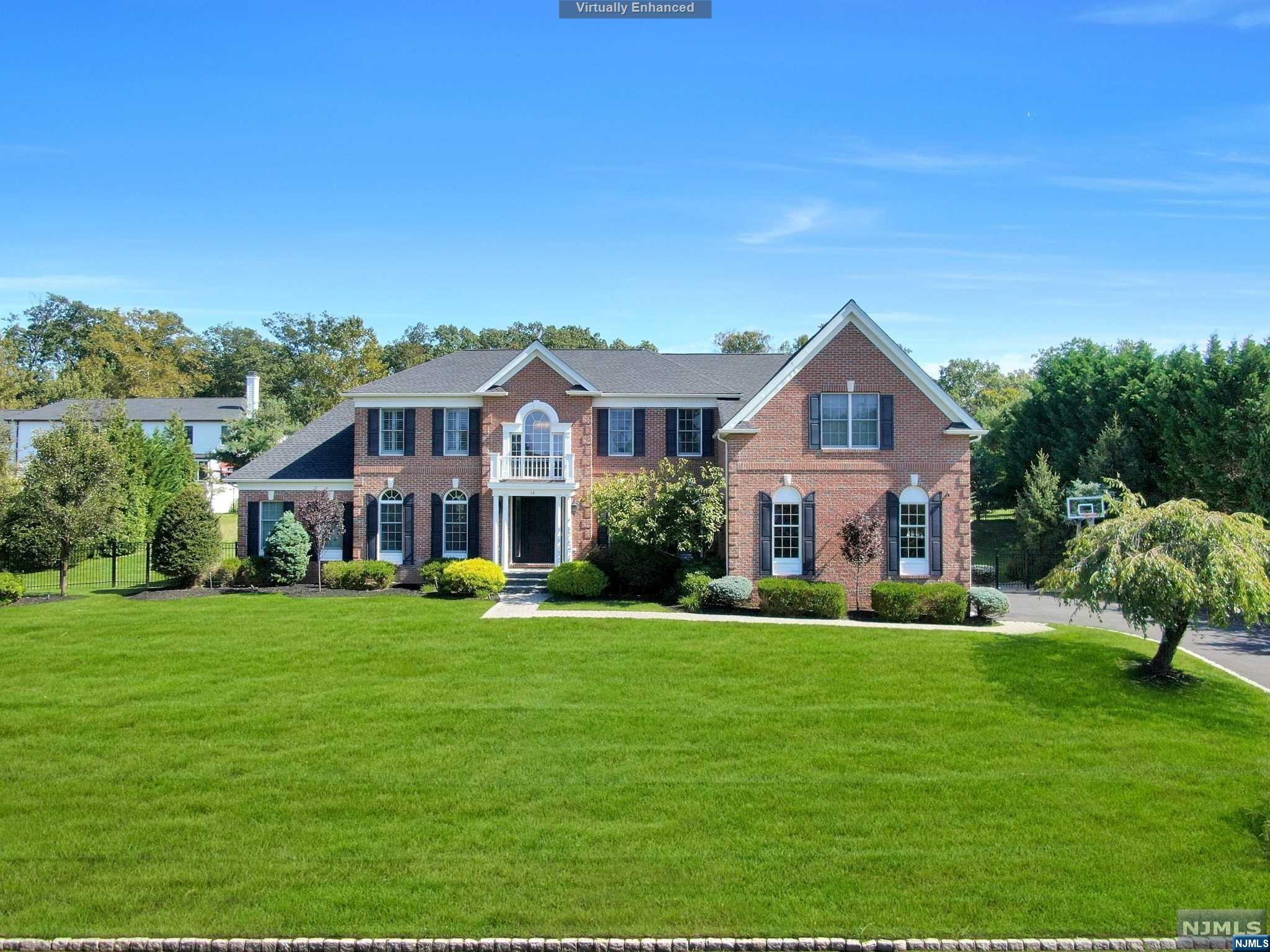 Nestled in the heart of Woodcliff Lake's Mulholland Estates, this Pristine Center Hall Manor Home is a true masterpiece of upscale design. The 2-story Grand entry foyer sets the tone, opening to an extraordinary Library/5th Bedroom & an inviting Living Room. The Cathedral ceiling Solarium offers magnificent space. The Center Island Kitchen could easily grace the pages of a design magazine, blending quartz, stainless steel & floating white cabinetry, opening to the 2 Story Great Room w/Fireplace. The incredible Primary Suite features a beautiful Sitting Rm, large Walk-in Closet & Primary Bath w/high-end design. Another Bedroom is En-Suite w/Full Bath, & two Additional Bedrooms have a Jack & Jill Bath. An expansive finished lower level w/High Ceilings features a media room, rec room, office, exercise room & bath. A 3 Car Garage, & Brick & Hardy Plank Siding complete this Remarkable home, located close to its top rated schools & NYC transportation! Absolutely Stunning!