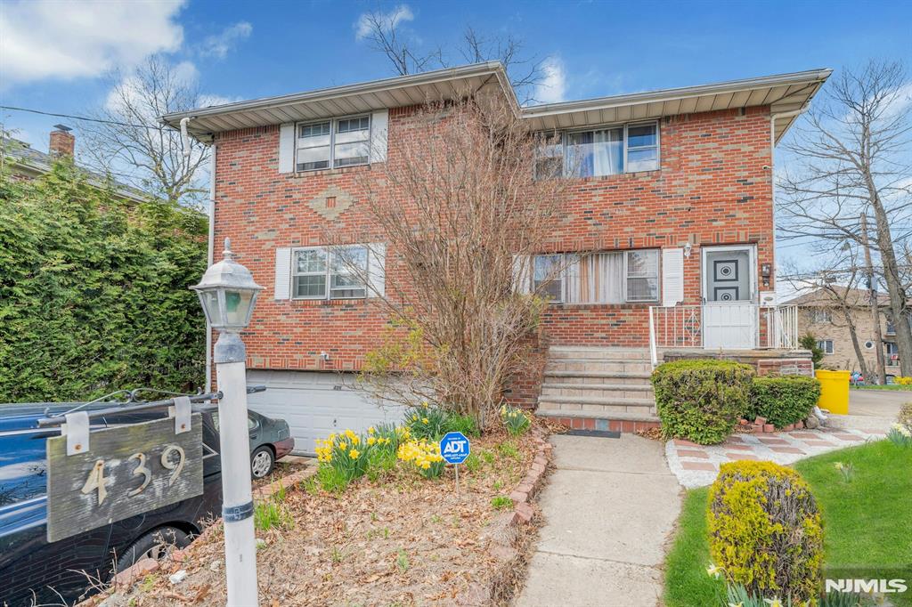Prime Palisades Park Opportunity | Oversized Brick 2-Family with NYC Proximity. Discover the perfect blend of scale and potential at 439 Bergen Boulevard. This all-brick legal two-family residence is set on a rare oversized lot measuring 166/160 x 64/11 in one of Bergen Countyâ€™s most desirable markets. Positioned on an extra-deep, elevated lot, this property offers exceptional value compared with smaller recent sales in the area. The interior features a well-balanced 5-bedroom, 3-bath layout with sun-filled living spaces and classic hardwood flooring throughout. Both the upper and lower units include spacious eat-in kitchens and generously sized bedrooms. The walk-out ground level adds tremendous flexibility with a large recreation room, full bath, and separate entrance, ideal for guests or extended living arrangements. Additional highlights include an attached 2-car garage, a 4-car driveway, and additional street access on 10th Street. The expansive side yard on this extra-deep lot offers excellent outdoor space for recreation or future expansion. Conveniently located near Broad Avenueâ€™s dining, shopping, and markets, with easy access to NYC transit and the George Washington Bridge. Enjoy the benefits of a strong rental market and long-term appreciation potential. Sold as-is, this property presents a rare opportunity and a true canvas for your vision!