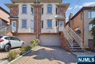 Spacious South-facing brick duplex. Built in 2005,this bright and spacious solid brick duplex offers the perfect blend of quality construction and modern comfort.Bathed in natural lights thanks its desirable south-facing exposure.The home features hardwood floors throughout,creating s warm seamless from room to room.The modern eat-in kitchen is appointed with Corian countertops and a new S/S refrigerator,while the inviting living room centers around a gas fireplace-ideal for cozy evening at home.Step outside from dining area onto a private wooden deck,perfect for outdoor entertaining.Replaced HVAC air conditioning system,heating boiler and hot water tank within a few years ago.Additional highlights include a central vacuum system,an attached two-car garage,and a prime location on the east side of Palisades,directly adjacent to the Fort Lee border.Commuters will appreciate the easy access to New York City.A rare opportunity to own a home in one of Bergen County'most convenient and sough-after location.3 bedrooms,3 and half bathrooms.Lot size 25X 100.