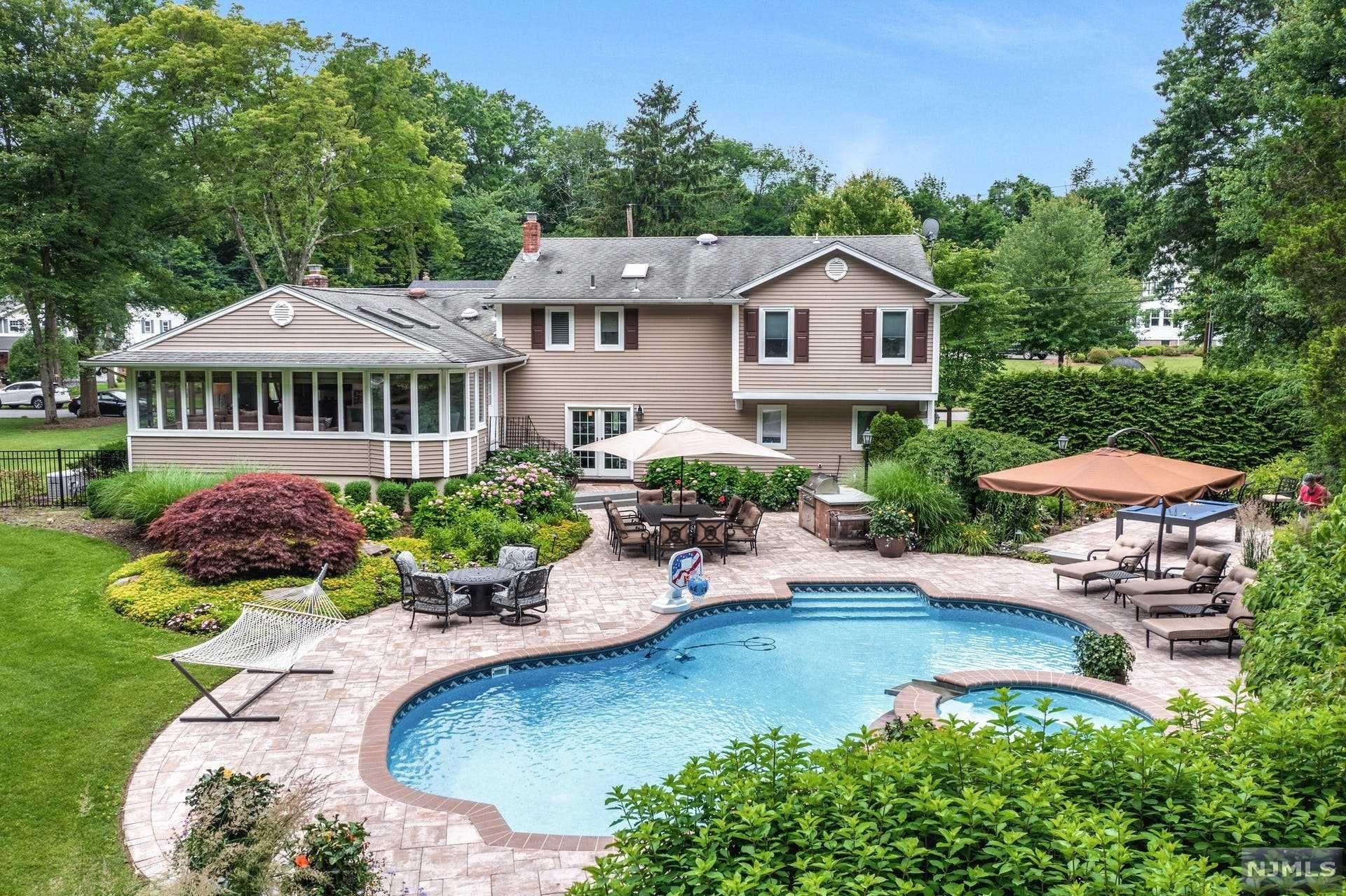 This home is PRISTINE! Well cared for, well appointed, and Well, It's everything you imagined! An outdoor OASIS as LUSH as any vacation RESORT. Perennials will keep you walking around your property for hours on end with visual amazement. Sonos outdoor music system, Gas BBQ, and all year hot tub to enhance every outdoor experience. Inside, you have plenty of versatile living space including Marble entry foyer, french doors to walk out office, mudroom/laundry and half bath off pool. Downstairs is an extra room with full bath and a large Recreation Room with FP. The First floor has FLR FDR and Beautiful VAULTED Back of the house GLASS window surround Living Space. Modern Kitchen with Stainless steel appliances, Insinkerator, Instant hot and Whole house water filter/purifier by Leak Smart. Whole house generator, indoor surround sound, central vac ..... it's only the beginning. Get ready to make your dreams a reality and build memories of a lifetime!!!