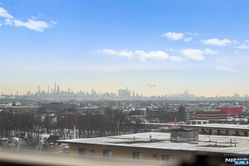 This oversized 1 bed co-op offers over 1,000 sq.ft of bright, well designed living space with sweeping NYC skyline views. Featuring tall ceilings, generously sized rooms, and a highly functional layout, this home delivers both comfort and flexibility. A welcoming entry foyer leads into an expansive living room and a formal dining area that can easily be converted into a den or home office. The eat in kitchen offers excellent storage and workspace, while the massive primary bedroom includes two large closets and easy access to the nicely updated bathroom. Thoughtful updates, ample storage, and an open flow make this unit ideal for both everyday living and entertaining. The Whitehall is a full service luxury building offering 24 hour doorman and security, a state of the art fitness center, outdoor pool with lounge area, BBQ space, community room with kitchen, on site management office, and a full time resident building manager. Reserved parking is available for a small additional fee. Perfectly located with an NYC Express bus right in front and train service just a few blocks away, this home offers unbeatable convenience for commuters. The monthly HOA fee includes taxes, insurance, gas, electric, water, storage bin, common area maintenance, and all building amenities. With continued redevelopment throughout Hackensack driving increased demand and long term value, this is an excellent opportunity to own in one of the area's most established and well regarded buildings.