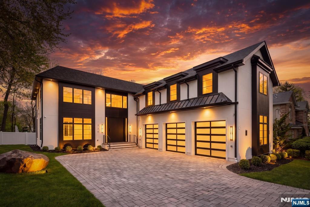 Modern Architecture meets Elevated Design at this New Construction home by Lodhra Modern Builders. This bespoke residence offers close to 8,000 SF of living space & makes an immediate impression with a dramatic double-height foyer w coiffured ceilings, oversized pivot entry door, & designer lighting. Designed for both grand entertaining & everyday living, the home features 10-ft ceilings and expansive windows that fill the interiors with natural light. The centerpiece is a showstopping chefâ€™s kitchen with backlit Cristalo double waterfall islands, custom cabinetry, and premium appliances, complemented by a hidden pantry room. The adjoining family room offers soaring ceilings, a sleek fireplace, and seamless indoor-outdoor flow. The striking dining room offers a butler's pantry for the ultimate in entertaining. A first-floor guest en-suite completes the main level. The primary suite is a true retreat, featuring a custom walk-in closet w center island & a spa-like bath with a huge wetroom. Three other bedrooms with en-suite baths & WICs as well as a convenient laundry room complete the second floor. The walk-out lower level includes a spacious gym, theater, bedroom w en-suite bath, & recreation space with entertainer's bar, ideal for entertaining or extended living. Outdoors, enjoy a private setting with future pool potential, a 3-car garage, balconies, and modern stucco exterior, enhanced by smart features & speakers throughout, creating a seamless blend of luxury and comfor