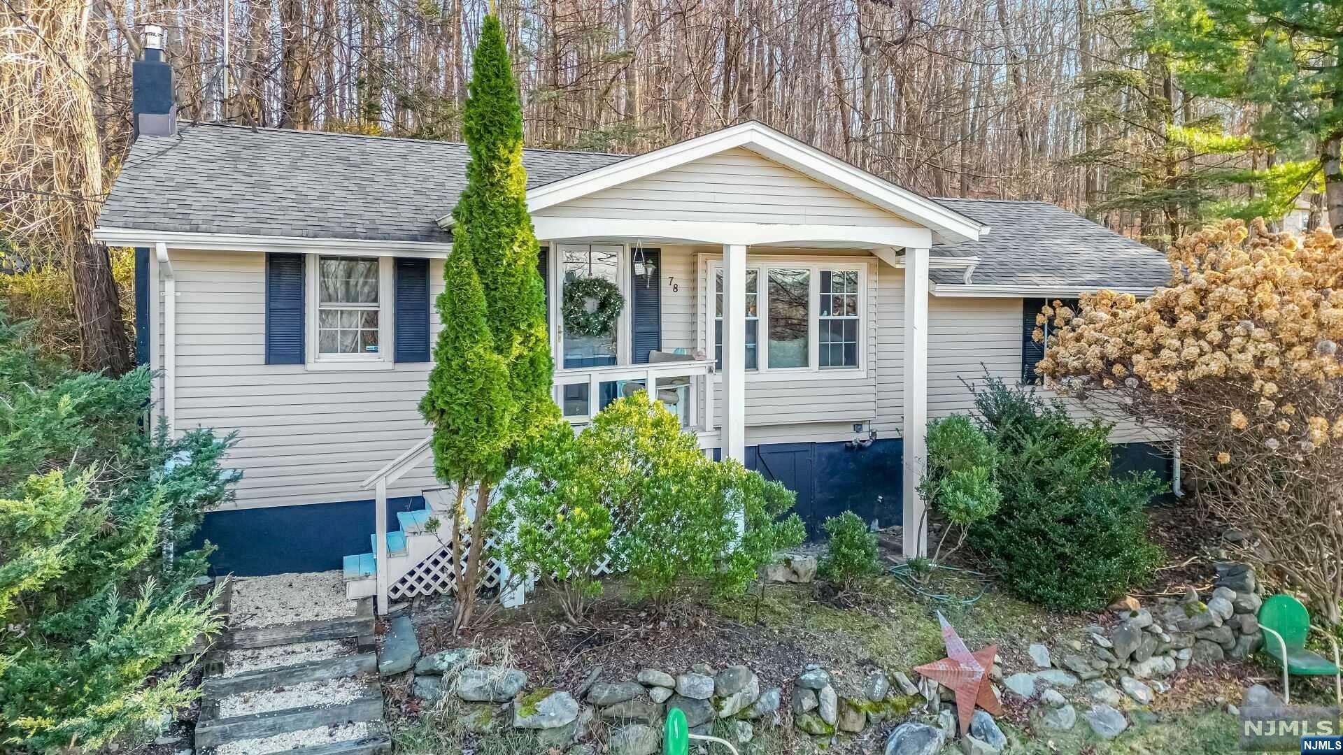 The lake lifestyle can be yours in one of New Jersey's most popular lake communities. This charming ranch with seasonal views of the water is located near the picturesque shores of Lake Mohawk. This property is a double-lot - a generous 120 feet wide - offering you extra room for outdoor fun or the potential to expand. The living room has a vaulted ceiling; in the family room there is a wood-burning stove. French doors open to a convenient and cozy outdoor patio. Updates include the roof (2018), windows (2005), furnace (2012), and new chimney liner (2021). An above-ground oil tank was removed in 2013 and a new tank was installed in the basement. Whether you're looking for a year-round residence or a weekend getaway spot, Lake Mohawk offers an idyllic retreat where you can create lasting memories with family and friends. Enjoy the beaches, swimming, boating, the clubhouse, outdoor tiki bar, waterfront dining, the boardwalk and all the nearby restaurants and shops.