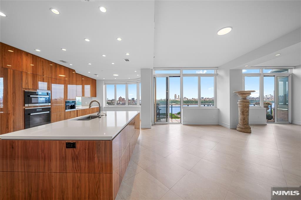 Stunning 2-story townhouse at The Villas in Carlyle Towers offering approx. 3,744 sq. ft. with breathtaking Hudson River and NYC skyline views. Features 4BR, 3.5BA, grand foyer with marble floors, soaring ceilings, and expansive living room with fireplace, oversized windows, and balconies. Custom built Eurostyle kitchen with high-end appliances( Subzero, Wolf, and Miele), custom cabinetry, quartz countertops, and built-in espresso machine. Lower level includes 2 en-suite bedrooms and a luxurious primary suite with private balcony. Marble floors, custom woodwork, and high-end finishes throughout. New full HVAC system (no wall units). Custom LED lightings and Fixtures. Full-service luxury amenities include 24-hour concierge/doorman, porter service, valet parking, gym, and outdoor pool. Prime location near NYC transportation, shopping, and dining. Donâ€™t miss the opportunity to own this one-of-a-kind home with unparalleled views and amenities.