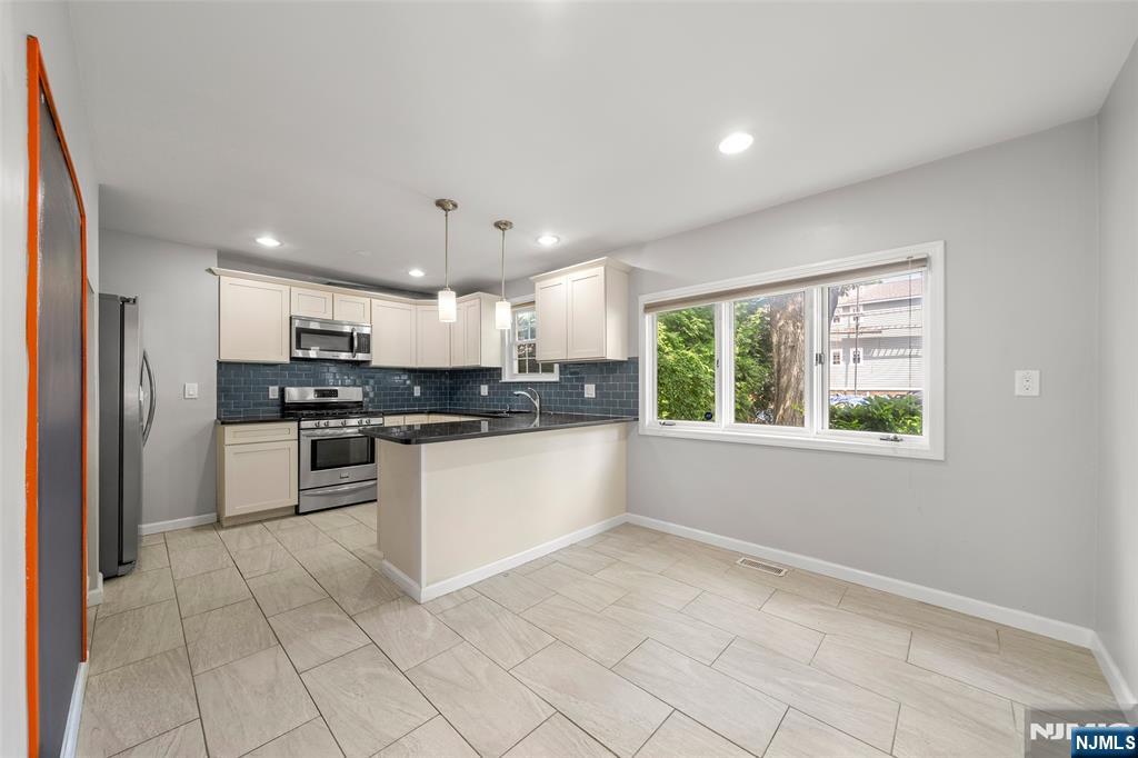 Beautifully updated home in the heart of Elmwood Park! A spacious entry hall leads to a bright first floor with a large living room, powder room, and a recently renovated eat-in kitchen. Three bedrooms upstairs provide privacy with separate entrances. The fully finished basement includes laundry, a full bath, and flexible space ideal for a home office, gym, or playroom. The roof and siding have just been completely replaced, and the interior features fresh paint and new stair carpeting. Enjoy a wide brick-paved backyard with fire pit, perfect for gatherings, plus a driveway accommodating up to three cars. Conveniently located near downtown, shopping, and transportation.