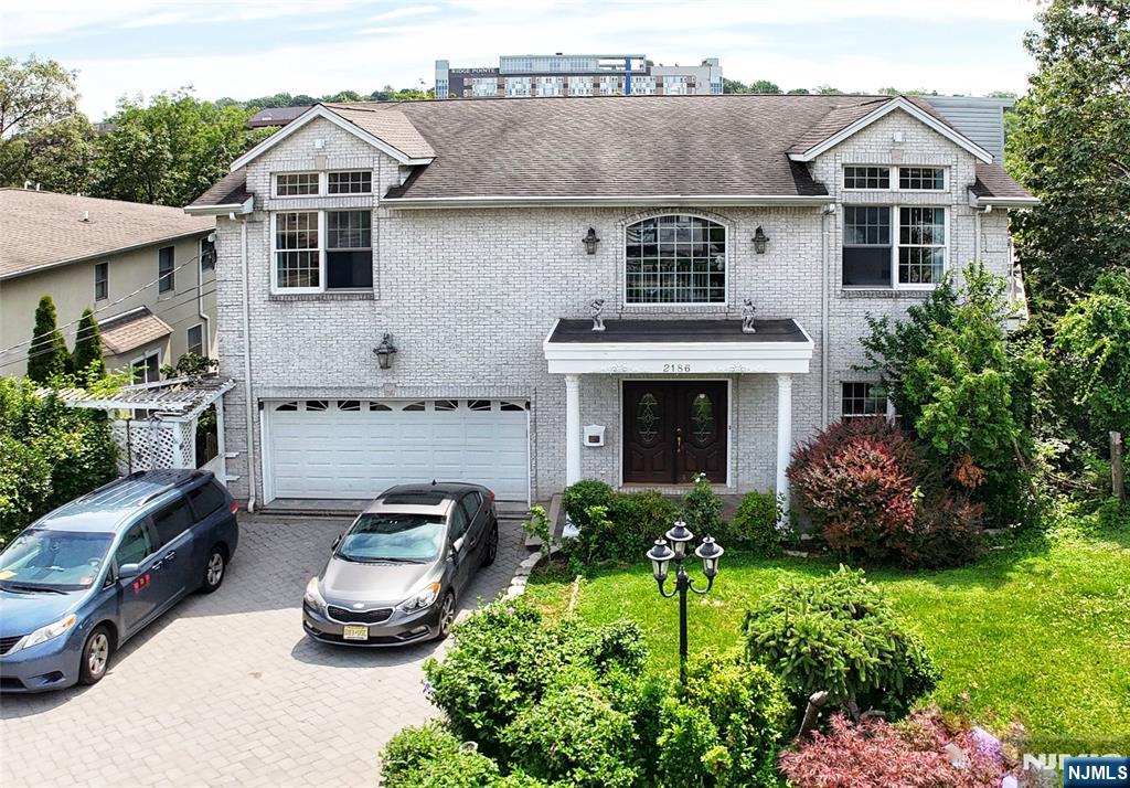 Welcome to this stunning and oversized center hall colonial located in the peaceful Fort Lee neighborhood less than 2 miles from the George Washington Bridge. With approximately 4,310sf of beautifully designed living space, this home offers timeless architectural charm blended with modern comfort - featuring soaring ceilings, exquisite trim work, and a unique, flowing layout rarely found in todayâ€™s homes. Step into the sun-drenched main level, where a gracious open floor plan effortlessly connects a chefâ€™s kitchenâ€”complete with a center island and breakfast areaâ€”to the inviting living room with fireplace, an oversized formal dining room, and a spacious family room, perfect for entertaining or everyday living. Upstairs, retreat to the primary suite, featuring a cozy fireplace, generous walk-in closet, and a spa-like en-suite bathroom with a jacuzzi tub and steam shower. The second floor also offers a private en-suite bedroom and two additional spacious bedrooms, both with ample closets and private balconies for added charm. Large windows throughout the home flood the interiors with natural light, highlighting the scale and flow of each room. The lower level is ideal for multi-generational living or guests, featuring a fully equipped guest suite with a living area, summer kitchen, bedroom, office space, full bath, and glass doors that open directly to the backyardâ€”perfect for a private retreat or extended stays. Owner has NJ real estate license.