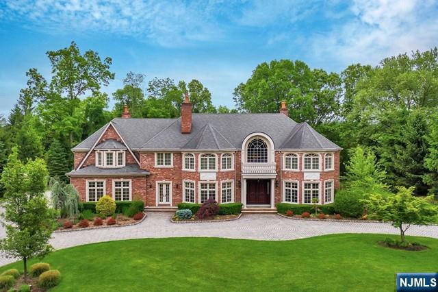 Stately, custom Leonard-built, all-brick, steel-beam construction Colonial gracefully set on a spectacular, private cul-de-sac. A sweeping paver circular driveway creates a grand first impression while beautifully framing the homeâ€™s timeless architecture. Inside, exceptional craftsmanship & grand-scale living unfold. A dramatic two-story entry foyer welcomes you into refined spaces, including a banquet-sized DR with fireplace & a sophisticated office featuring custom millwork & wet bar. The 2story great room showcases soaring windows, a fireplace, & French doors that open seamlessly to the bluestone patio & lush grounds. Designed for both everyday living & elevated entertaining, the chefâ€™s kitchen is appointed with custom cabinetry, granite countertops, a generous center island, professional-grade appliances, & a spacious breakfast area. The kitchen flows effortlessly into a family room with fireplace, creating a warm & inviting space. A 1st floor bedroom ensuite offers flexibility. Upstairs, the luxurious primary suite is a true retreat, featuring a sitting area with fireplace, spa-inspired bath, dual walk-in closets, dressing salon, & a gym/office. The fully finished walk-out lower level is designed for unforgettable entertaining, complete with a custom pub, billiards area, wine cellar, game room, & a family room with stage. The flat, level property offers exceptional privacy with a serene wooded backdrop & plenty of room for a pool. A rare find!
