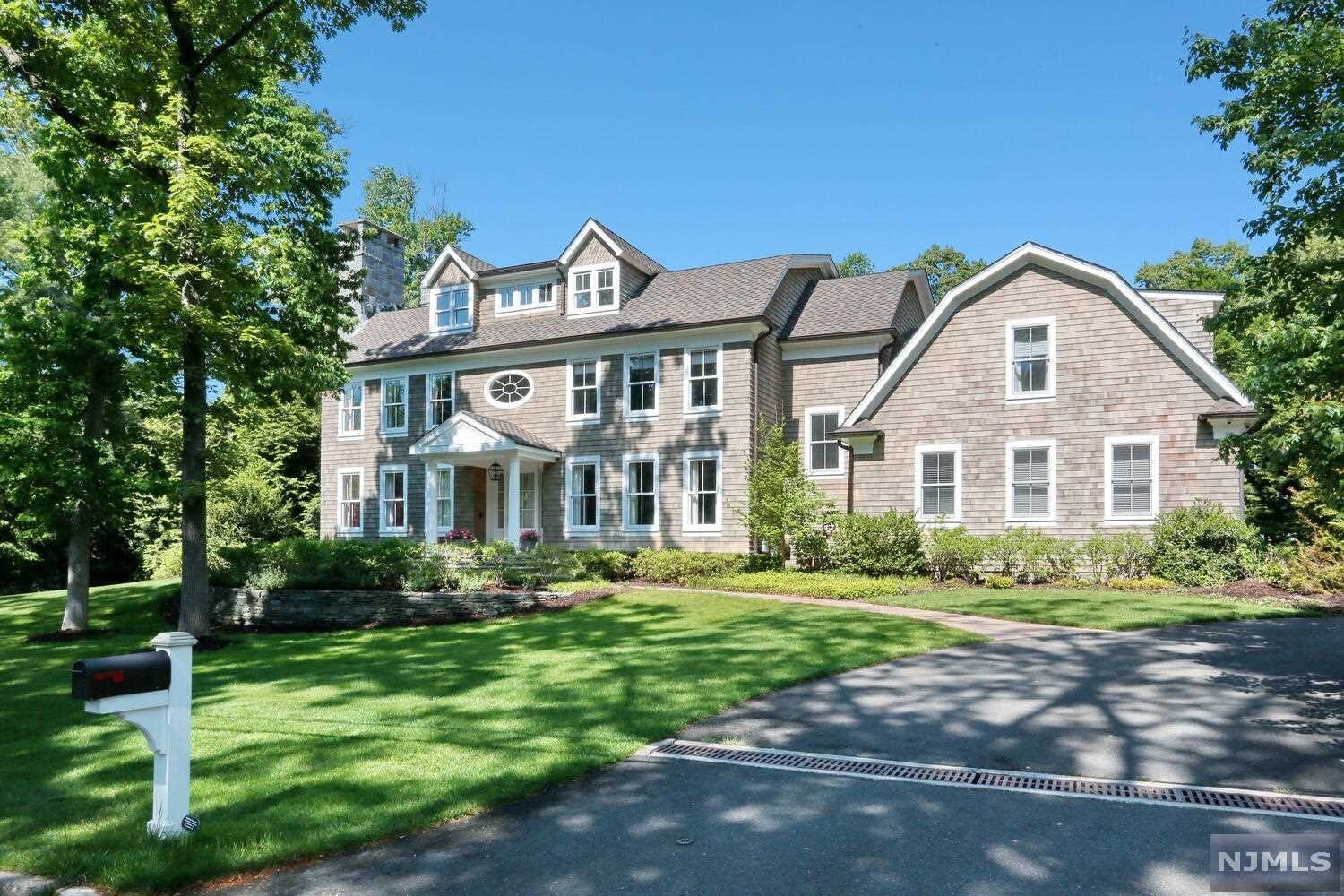 This stunning Dutch Colonial sits perfectly on an acre, surrounded by lush gardens & backs up to wooded land for total privacy. So many amenities, inside & out. Designed & constructed with high-end luxury finishes and cutting edge/efficient mechanical systems. Enter into the grand center hall, living rm/fpl, banquet size formal dining rm, butlers pantry leading into the gourmet kitchen, family rm/fpl, powder rm, back staircase, mud rm,office/br, fbthf/ss, 3 season sun rm/fpl. The 2nd floor offers a master br suite, his & her luxury baths, br/fbth,br/fbth, laundry rm, br, fbthf/sot,br/music rm. Full-finished walk-up attic. This home offers rooms for everything. The elevator garage brings you down to the basement where you have add'l car parking, recreation rm/fpl, gym, wine cellar, fbthf/ss/sauna, wet bar. The beautiful reclaimed wood-lined detached garage is all temp-controlled and offers endless opportunities. Saltwater pool. Garden shed.