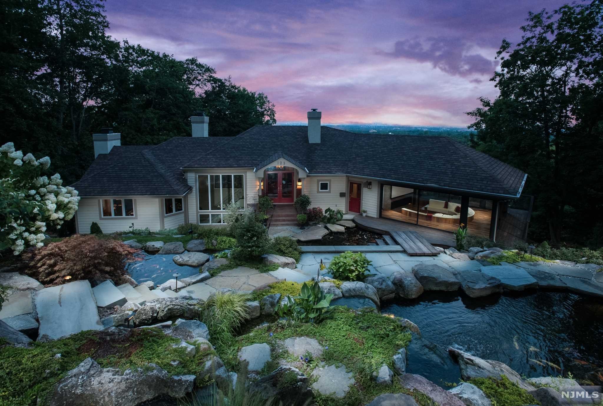 This 7000 square foot Montclair contemporary is an entertainer's dream home. Welcoming visitors with cascading koi ponds and waterfalls, complete with lush landscaping and pristine gardens, this property is one for the ages. This contemporary home amazes with dramatic walls of glass accentuating panoramic NYCskyline views. Star gaze or view the twinkling lights from the Living Room, Kitchen, Screening Room, Dining Room, Bedrooms or decks. The Kitchen is a gourmet's delight with large island and stainless steel appliances. The Family Room, 2 Offices and 2 PR complete this floor. 5 large Bedrooms and 5 additional Baths, allupdated, occupy the other levels, plus a world class Game Room complete w/wet bar, wine fridge and more. A spectacular pool, outdoor kitchen, patios and a firepit help make the yard a FIVE STAR resort!