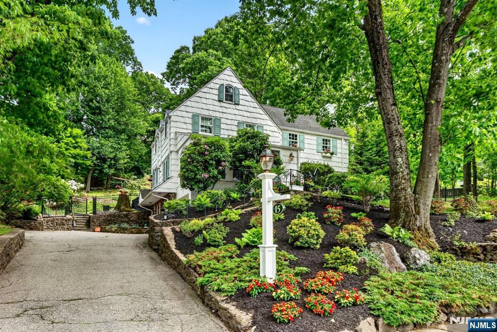 Welcome to the Afterglow Section, one of Verona's most sought-after locations, where this timeless Colonial's charm meets exceptional convenience and lifestyle. Perfectly positioned just one block from the breathtaking 400+ acre Eagle Rock Reservation, this sun-drenched residence offers gracious living spaces, thoughtful updates, and an unbeatable setting. Filled w/natural light, the home features expansive rooms throughout, including a welcoming Living Rm w/fpl , spacious Fam Rm, and an updated kitchen designed for both everyday living + entertaining w/peninsula, center island, + separate Breakfast Rm. A private 3-season porch provides the perfect place to unwind while taking in stunning sunset views. The 2nd floor offers 3 spacious bedrooms and 3 full baths, plus a serene Primary Suite complete w/ fpl and updated bath. The 3rd floor provides a private retreat w/additional large bedroom, full bath, and abundant storage ideal for guests, home office, or flexible living space.The finished lower level adds exceptional versatility w/large Rec Room, a 2nd Powder Room, storage, + utility space. Set on nearly half an acre, the fully fenced property offers a large flat yard for entertaining and play, while the wooded sloping side yard creates a rare sense of privacy. Enjoy unparalleled convenience just one block to the NYC bus and moments from Whole Foods, the Montclair Art Museum, vibrant downtown shopping and dining, Verona Park, and all the best of Verona and Montclair living.