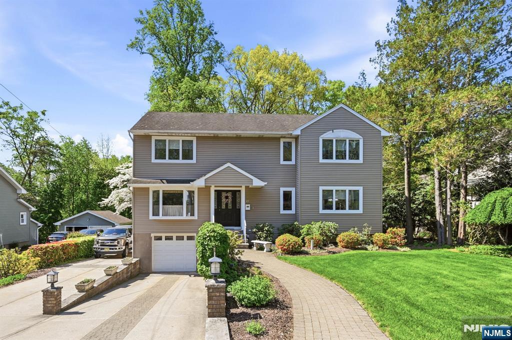 Pristine 4 bedroom, 4 bath Colonial perfectly blends classic charm with flowing open floorplan. Soaring 2-story entry foyer welcomes you into this craftsman's custom built home with detailed woodwork throughout. Sunny and inviting living room and dining room open to the granite and stainless kitchen with breakfast bar leading to the spectacular Great Room with coiffered ceiling, skylight amd fireplace! There is a first floor bedroom and full bath-- ideal for extended family or guests. Upstairs the large primary suite with walk-in closet and private jacuzzi bath is the perfect retreat. Two generous bedrooms and full bath complete the second floor. Downstairs you will find additional living space in the finished rec room with full bath and mud room leading to the 2-car tandem garage. Enjoy the expansive deck overlooking your private 200' deep picturesque property! Conveniently located to top-rated Park Ridge schools, shopping , restaurants and NY transportation. A must see!