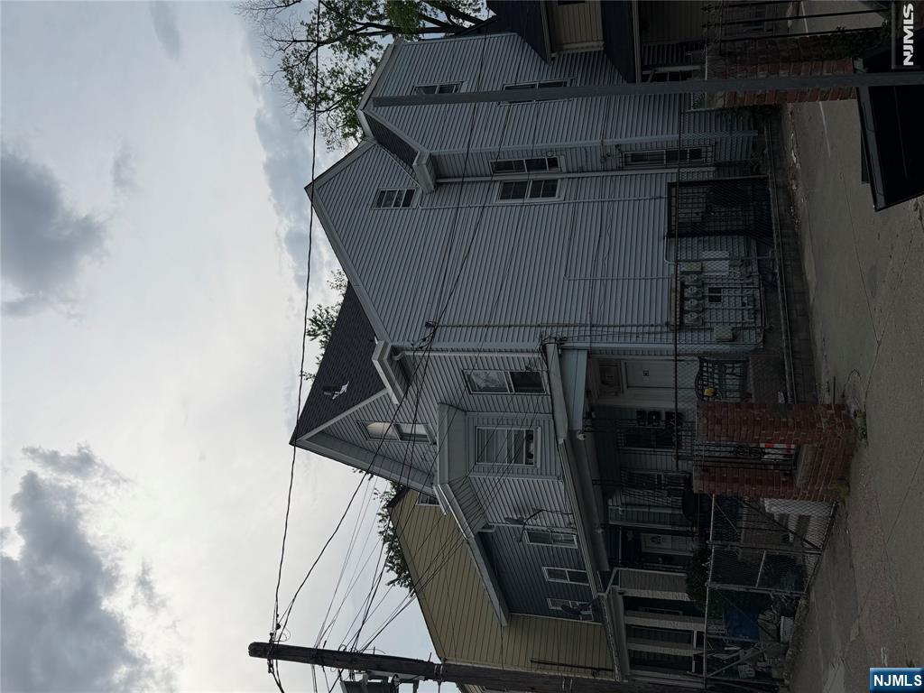Attention Investors and First-Time Buyers! This legal 3-family house offers an excellent opportunity to generate rental income. Live in one unit and let the others help offset your expenses, or maximize its full investment potential. The 1st and 2nd floors each feature 3 bedrooms, while the 3rd floor offers a 1-bedroom unit. Recent updates include a newer roof (2022) and solar panels, which will be fully paid off by the seller and will be transferred to the new owner at closing. The property also features a full finished basement and separate utilities for each unit. Conveniently located near transportation, shopping, schools, and major conveniences. The 1st-floor unit will be delivered vacant at closing. No current leases are in place. Green Card will be provided by the seller. PROPERTY BEING SOLD IN AS-IS CONDITION