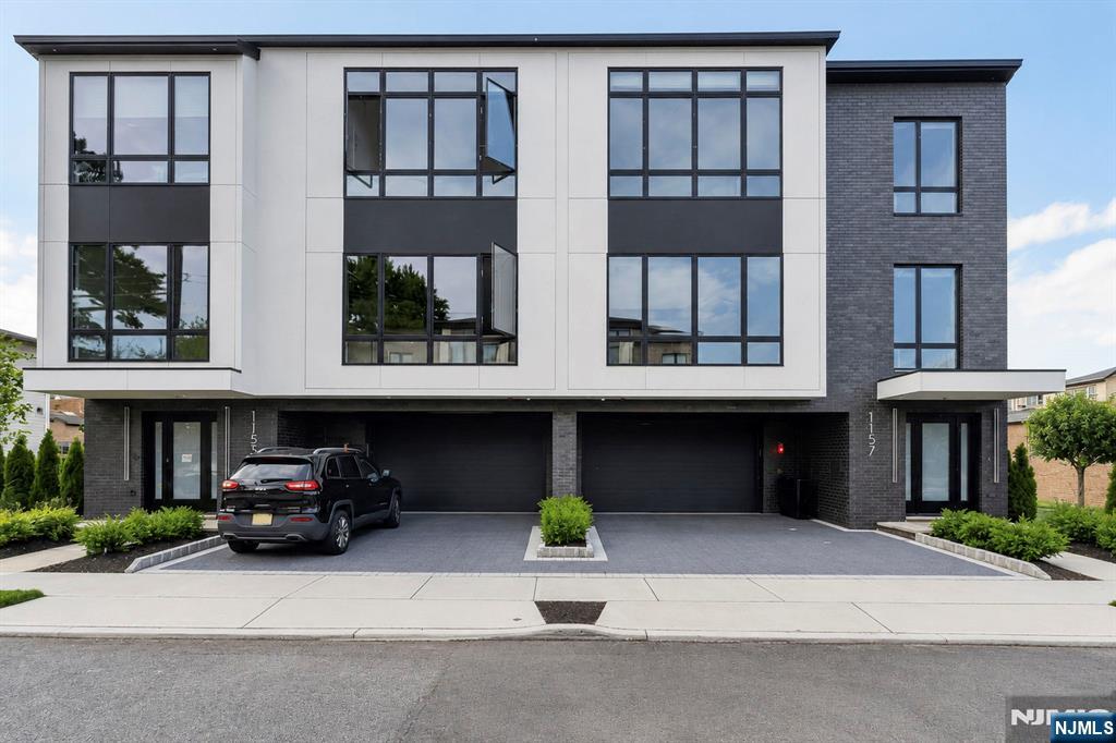 BRAND NEW LUXURY 4 STORY TOWNHOUSE LOCATED CONVENIENTLY IN THE HEART OF FORT LEE. MAIN LEVEL FEATURES OPEN FLOOR PLAN WITH FLOATING STAIRCASE AND 9' CEILING, LIVING ROOM WITH GAS FIREPLACE, DINING ROOM, MODERN KITCHEN WITH OVERSIZED ISLAND, BREAKFAST NOOK, AND SLIDING GLASS DOORS TO DECK....PRIMARY BEDROOM WITH 11' CEILINGS, TWO WALK IN CLOSETS, OVERSIZED WINDOWS, AND BATH WITH FLOATING DOUBLE VANITY WITH LED LITE MIRRORS, GLASS ENCLOSED SHOWER, AND FREE STANDING TUB...ANOTHER TWO ADDITIONAL BEDROOMS SHARE THE HALLWAY BATHROOM...STAIRCASE LEADING UP TO ROOFTOP LOFT COMPLETE WITH WET BAR AND HALF BATHROOM AND TERRACE BOASTING SPECTACULAR VIEWS OF MEADOWLANDS AND PERFECT FOR RELAXING AND ENTERTAINING....GROUND LEVEL OFFERS TWO CAR GARAGE, RECREATION ROOM, FULL BATHROOM, AND SLIDING GLASS DOORS TO SIDE YARD....AVAILABLE NOW FOR IMMEDIATE MOVE IN.