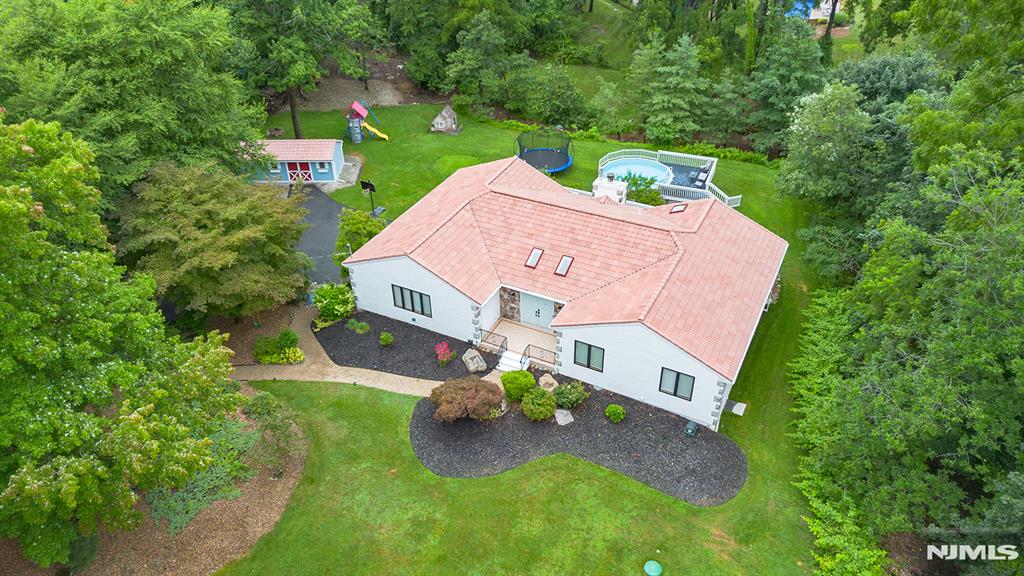 Your dream home has arrived! Set on a spectacular lot with an expansive deck, above-ground pool, and plenty of space to relax or entertain, this sprawling custom ranch offers the perfect blend of comfortable living, flexible space, and everyday convenience. Its convenient location provides easy access to shopping, dining, major highways, NYC transportation, and Kinnelonâ€™s outstanding school system. Live and entertain with ease as the home offers: a welcoming foyer, spacious living room, inviting family room with wood-burning fireplace, formal dining room, large eat-in kitchen with granite countertops, pantry, and slider to the full-length deck, updated bathrooms including a brand-new primary bath, generous bedrooms, and abundant storage. The fully finished walkout lower level provides exceptional versatility with its own kitchenette, dining area, living room, potential bedroom, and full bath, creating an ideal private suite for extended living, guests, or a variety of additional uses. A large storage shed and thoughtful updates throughout complete this exceptional opportunity. Donâ€™t miss this opportunity. Schedule your private tour today.