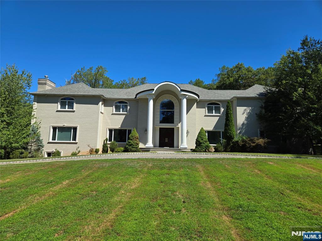 This stunning custom-built Colonial Manor is ideally situated on one of the townâ€™s most prestigious streets, spanning over two acres of manicured, private grounds. Featuring 7 bedrooms and 8.2 baths, including two luxurious primary suites, the home exudes comfort and sophistication. A dramatic two-story foyer with a sweeping staircase leads to a grand great room with soaring ceilings, sunlit windows, and an elegant gas fireplace. The chefâ€™s kitchen includes premium appliances, a prep kitchen, and a bright solarium with serene estate views. A private elevator serves all levels, while the lower level offers flexible space for a theater, gym, or recreation area. A true masterpiece of timeless design and refined living.