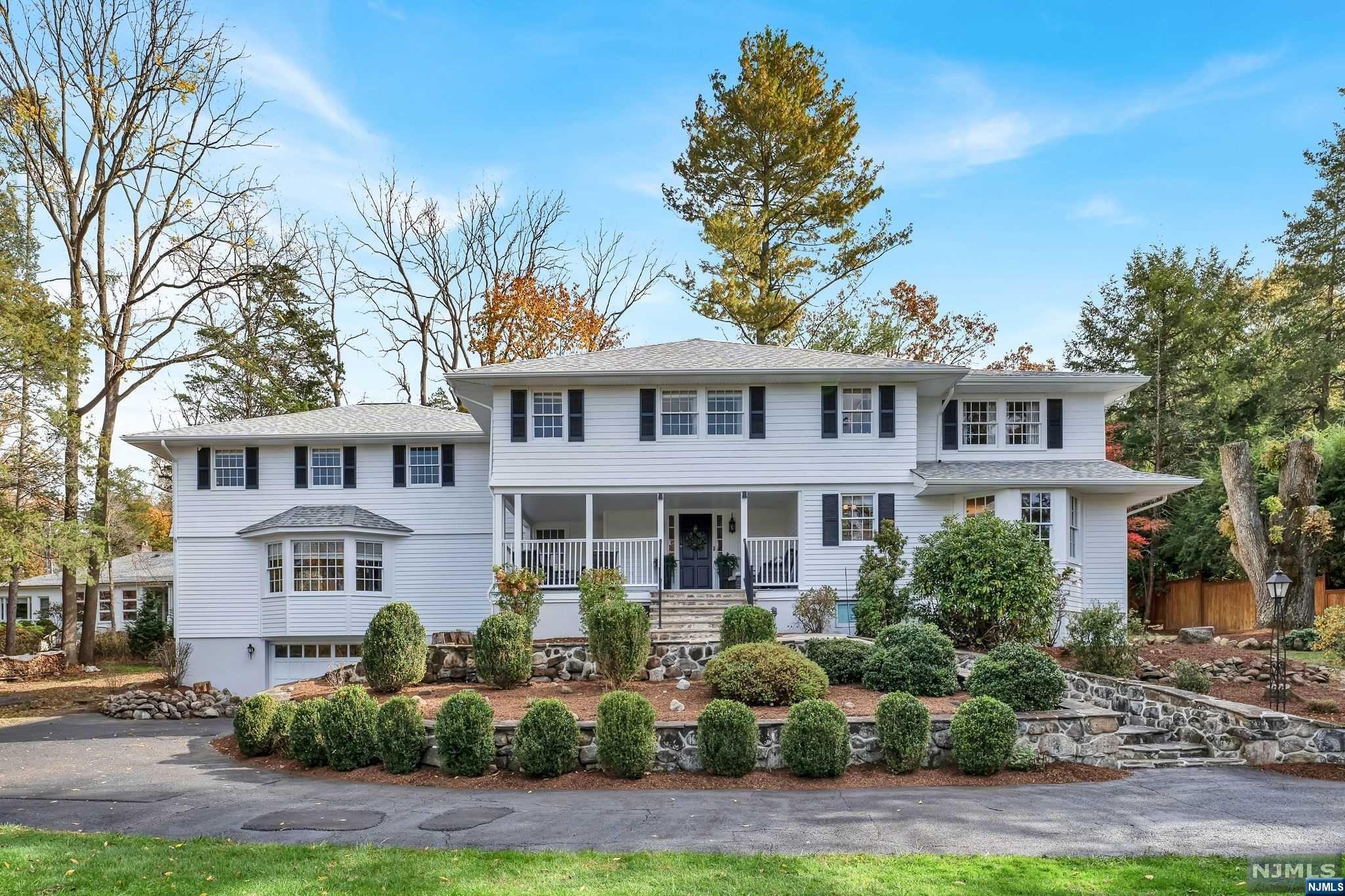 Magnificent & oversized Center Hall Colonial nestled in the Pine Lakes area of Wayne. Extensive front yard, circular driveway, & covered front porch. 2 story entry foyer w/ low rise grand staircase & chandelier, and 1/2 bath. Left of entry - large LR w/ wood burning fireplace & office w/ access to yard. Right side of entry - large DR, kitchen area has commercial appliances, 2 levels of work area, wine fridge, wet bar, & a butler's pantry w/ additional counter space & 2nd full size refrigerator. The gigantic FR has 2nd wood burning fireplace, a mudroom & a casual dining area. 2nd floor showcases large primary BR suite, soaker tub, & WIC. 2nd BR is adjacent to the main hallway with full bath directly across. BRs 3 & 4 are spacious in size with a full bath Jack and Jill style. Private rear yard includes a bluestone patio, fire pit & expansive wooded side yard area. Recent updates include new roof, gutters, exterior painted, driveway sealed, septic less than 4 years old, & more!