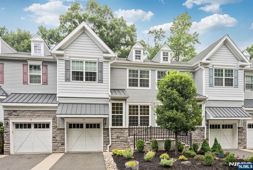 Drop your bags and move right into this pristine, fully renovated townhouse in Farm Estates. Showcasing approximately 2,700 square feet of finished living space across three levels, this exceptional home is appointed with high end finishes throughout. Upon entering, you're welcomed by gleaming hardwood floors, 9-foot ceilings, and an open concept layout. The beautifully updated eat-in kitchen features custom cabinetry, sleek granite countertops, and newer stainless steel appliances. The living room is anchored by a gas fireplace with a striking floor to ceiling stone accent wall and custom built-ins that add warmth and character. Upstairs, a spacious loft provides the perfect setting for a home office, or additional sitting area, along with a convenient laundry room. Three generously sized bedrooms include the luxurious primary suite, offering two walk-in closets and a spa-inspired bath with an oversized shower, double vanity and soaking tub. The fully finished lower level expands the living space with a large rec room featuring an electric fireplace, a full bathroom, and a versatile bonus room ideal as a potential 4th bedroom. Step outside to your private backyard retreat complete with a paver patio, beautifully landscaped grounds, and an 8-foot privacy fence--creating the perfect setting for relaxing or entertaining. Ideally situated just moments from NYC transportation and top-rated schools, this turnkey home delivers the perfect blend of luxury and convenience!