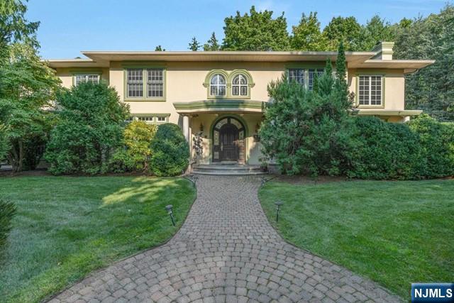 Custom built colonial set on approximately one half acre in the Strand section of Teaneck. Entry has sweeping staircase, elegant Living Room with Fireplace, grand Formal Dining Room with glass doors opening to patio, true Butler's pantry and gourmet kitchen including 3 dishwashers, Garland stove, large, windowed breakfast room, impressive office/library with custom bookcases, ensuite guest accommodations with private entranceway. 10 foot ceilings and mostly hardwood on first floor Second floor has Master Suite with private gym, laundry facilities, 2 ensuite bedrooms with full baths, 2 additional bedrooms, full bath. High ceilinged basement is a wonderland for kids or serious entertainment, Full Bath. Close to multiple houses of worship.