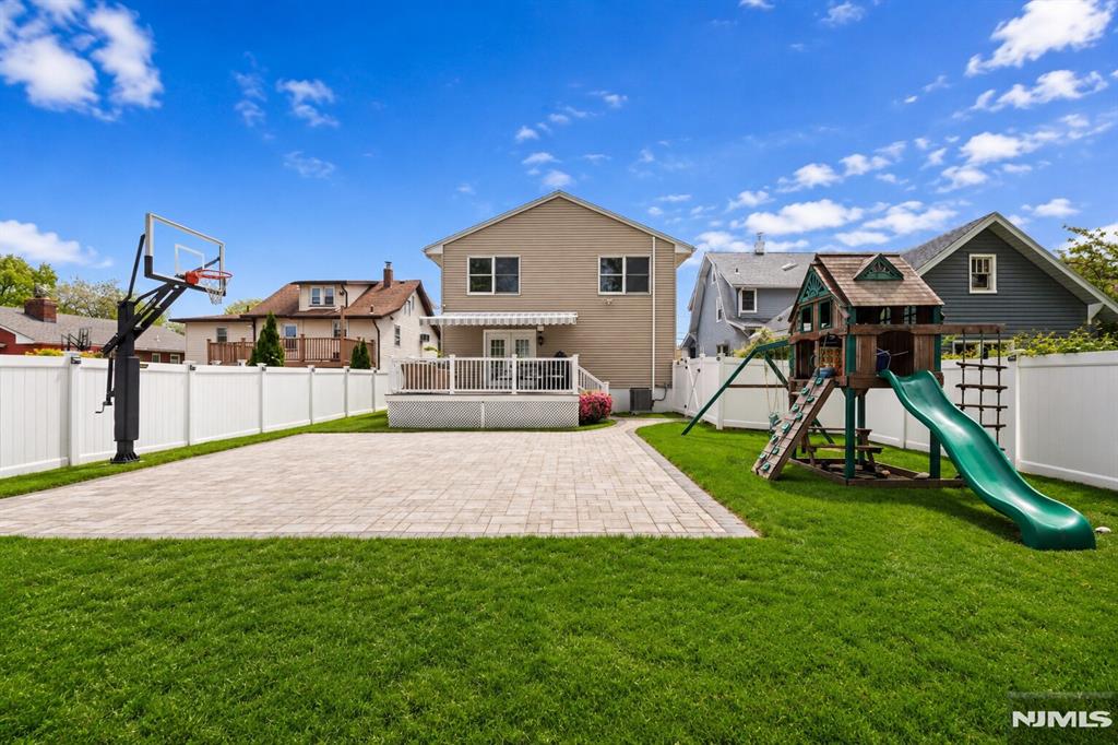 Welcome to this Bergen County home that delivers the space, flexibility, and outdoor lifestyle todayâ€™s buyers are looking for. This spacious 4-bedroom bi-level offers a highly versatile layout featuring 2 full kitchens, multiple living areas, vaulted ceilings, abundant natural light, and an attached 2-car garage. The thoughtful separation between the upper and lower levels creates ideal flexibility for extended households, multi-generational living, guests, home office needs, or anyone who would consider a two-family conversion in the future. The home feels bright, comfortable, and functional, with generous living spaces that can easily adapt to changing needs. Whether you are entertaining, working from home, accommodating family, or creating separate recreation and relaxation areas, this floor plan offers options that are increasingly hard to find. The backyard is a true showstopper. Exceptionally deep, fully fenced, and designed for enjoyment, it features extensive paver hardscaping, a basketball/sport court, Trex deck with motorized awning, mature landscaping, storage shed, and outstanding space for entertaining, play, gardening, or future pool possibilities. Located just one block from NYC bus transportation and minutes from schools, shopping, restaurants, major highways, MetLife Stadium, & American Dream. A rare opportunity to own a property with flexible living space, incredible outdoor amenities, and a location that works beautifully for commuters and everyday living