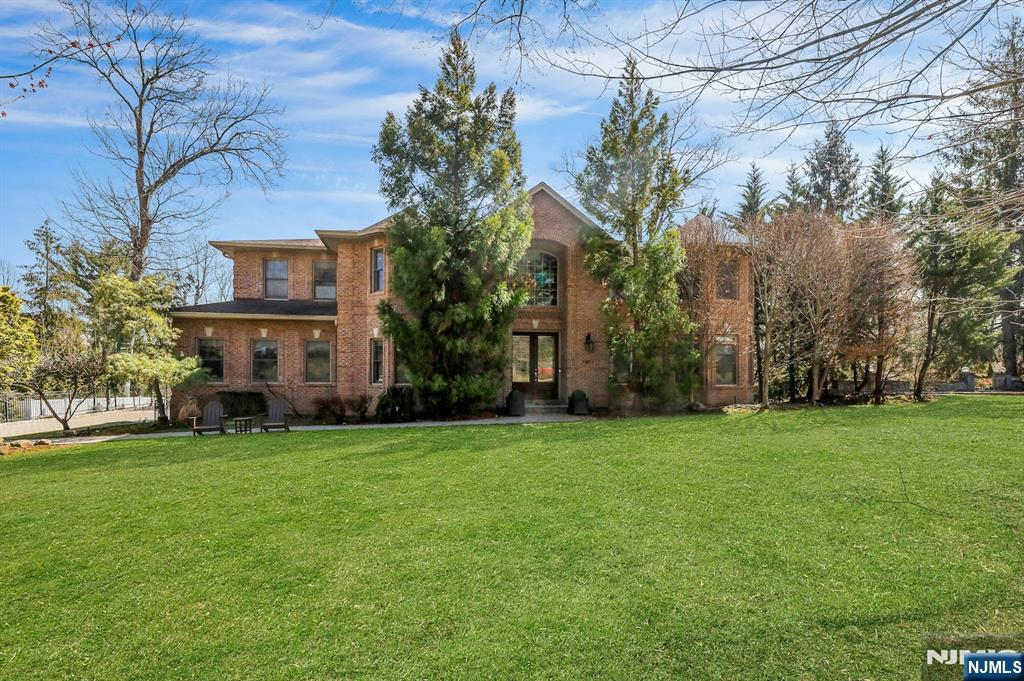 This exceptional all-brick colonial is built to the highest standards, showcasing timeless craftsmanship and refined architectural detail throughout. A bright, welcoming foyer opens to elegant living spaces and a beautifully appointed family room w/ 9-foot ceilings, intricate millwork, a fireplace, and a custom coffered ceiling. Divided-light oversized windows and French doors fill the home with soft natural light, enhancing its classic sophistication. The chefâ€™s kitchen features top-of-the-line appliances and flows seamlessly into a butlerâ€™s pantry with a built-in wine cooler and formal dining room. Radiant heat enhances comfort throughout the first floor and in the primary bath. Upstairs, the serene primary suite offers dual walk-in closets, a sitting area, and a spa-like bath, complemented by well-appointed bedrooms with ensuite or Jack-and-Jill layouts. The expansive walk-out lower level is a true extension of the home, complete with a fireplace, bedroom, full bath, and potential wine cellar. Bathed in natural light and surrounded by lush greenery, it offers exceptional privacy and effortless indoor-outdoor living - ideal for entertaining or a private retreat. Wired for indoor/outdoor surround sound, a possible wine cellar, a top-rated Blue Ribbon school district, offering convenient commute to NYC, and many more.