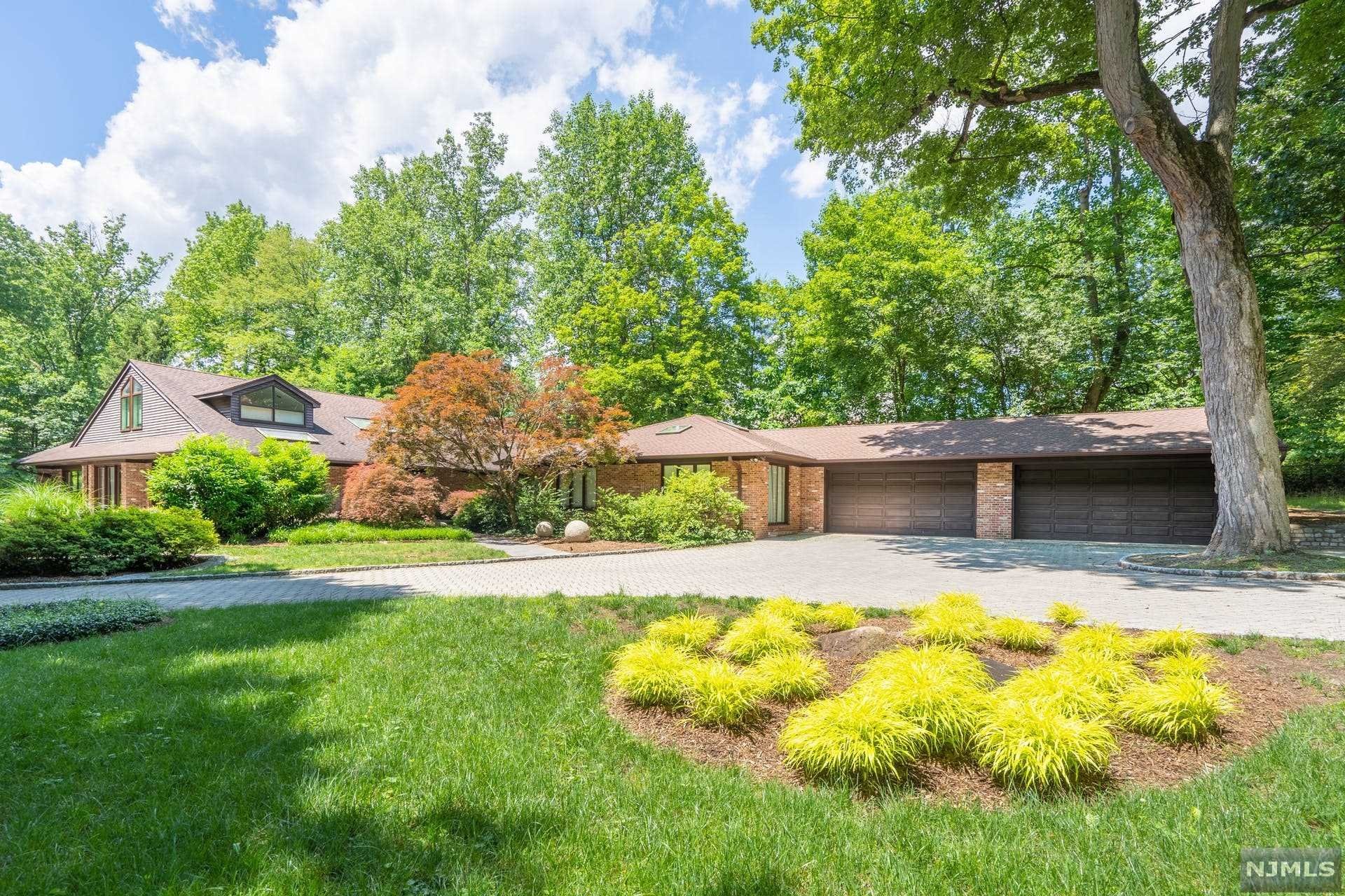 Private Oasis! Nestled into a bucolic mature landscape, you feel like you have reached your Vermont Country home when you enter the gated property, cross the bridge and pull into the Courtyard and 4 Car Garage. This all brick home features a sunlit entry, Large Eat-in Kitchen, Living Room with Fire place and Tray Ceiling, Large Dining room with access to Slate Patio and Sunny Atrium Family Room. A formal powder Completes this wing of the house. Enter the bedroom area through custom glass doors to the Master bedroom two-story suite including bedroom, sitting area, full bath, and spiral staircase to a private office and cedar closets. There are three additional bedrooms, 2 full baths, walk-in laundry room with sink & storage & family room. In additional there is a second floor bedroom suite accessible through a private entrance or through the kitchen . this can be used as an upstairs family room, guest or nanny suite. Custom Built and beautifully maintained, a must see!